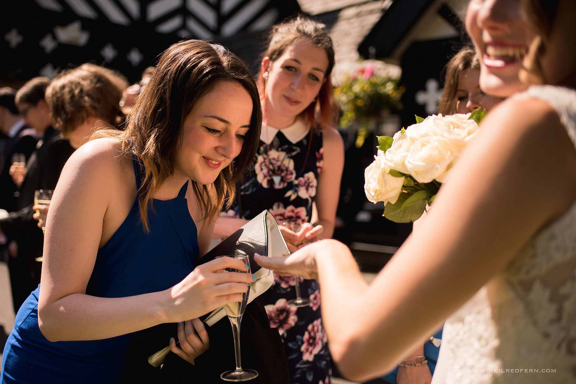 bride showing wedding ring to guest
