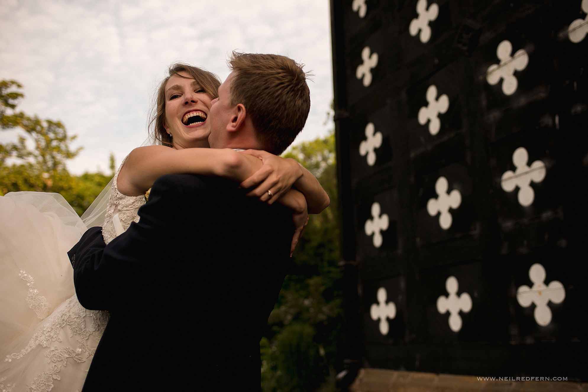 groom lifting up and kissing bride
