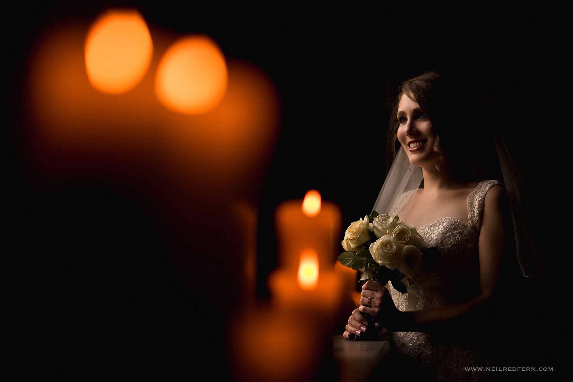 beautiful portrait of bride by candles