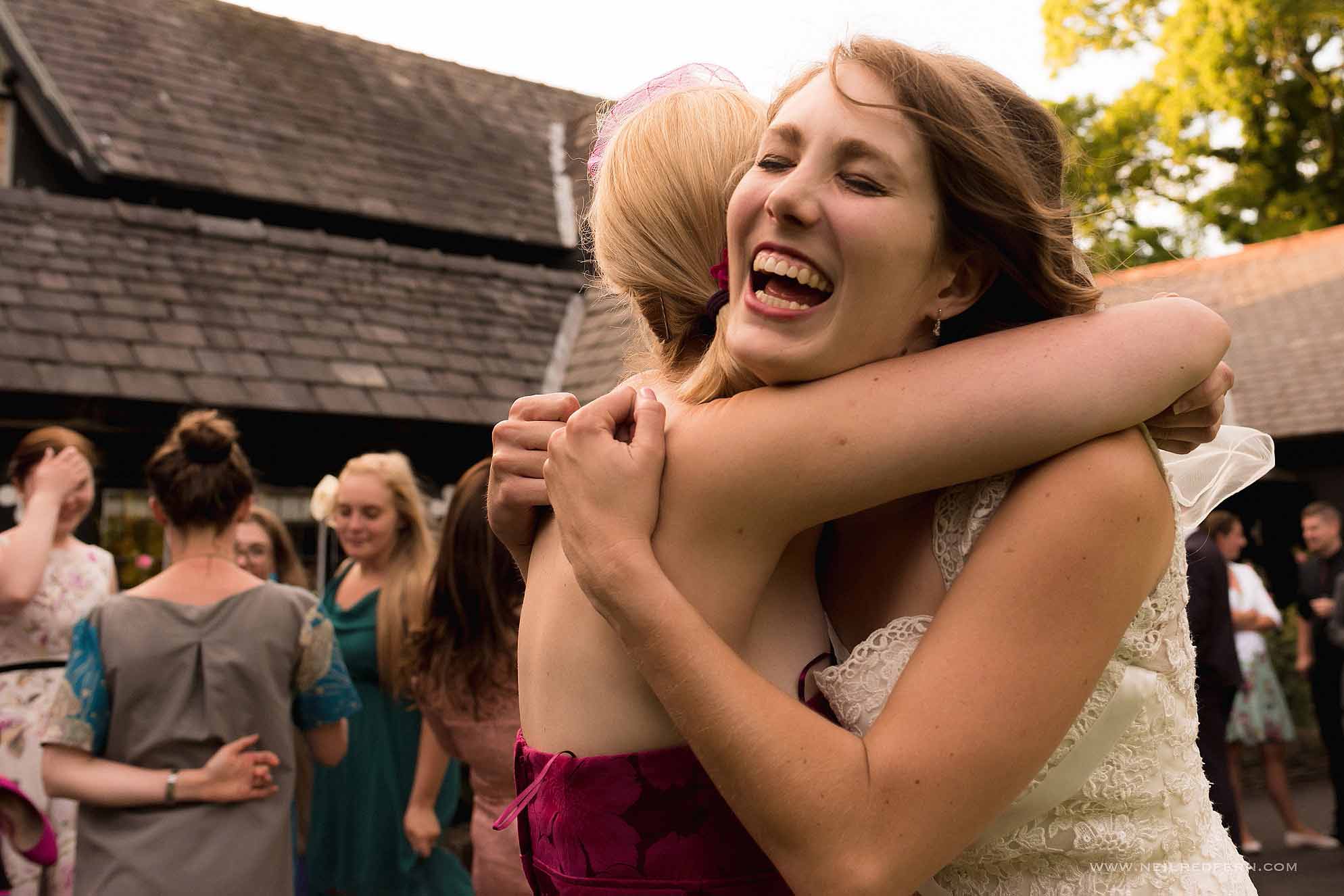 happy bride hugging friend