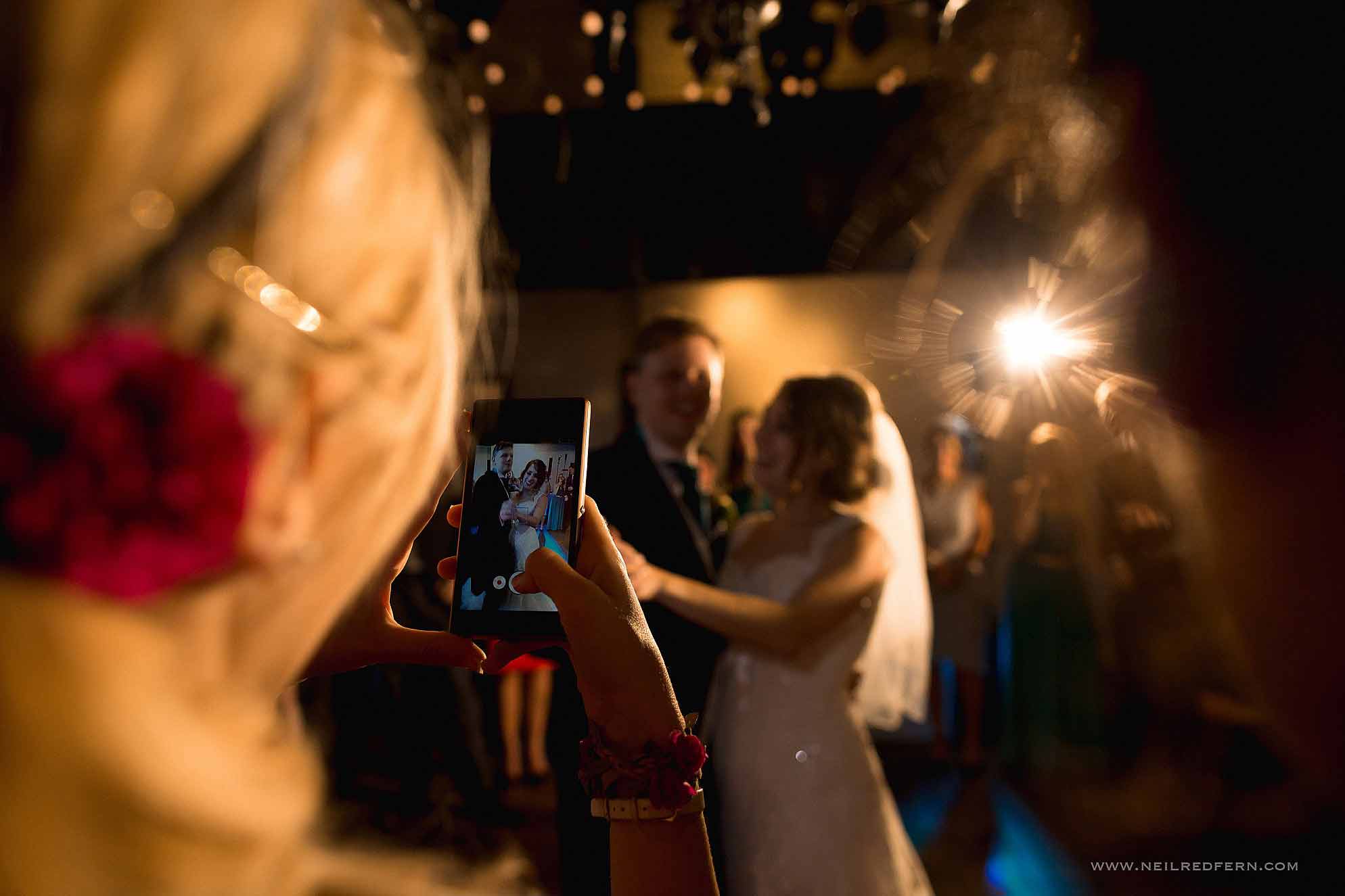 guest filming first dance on phone