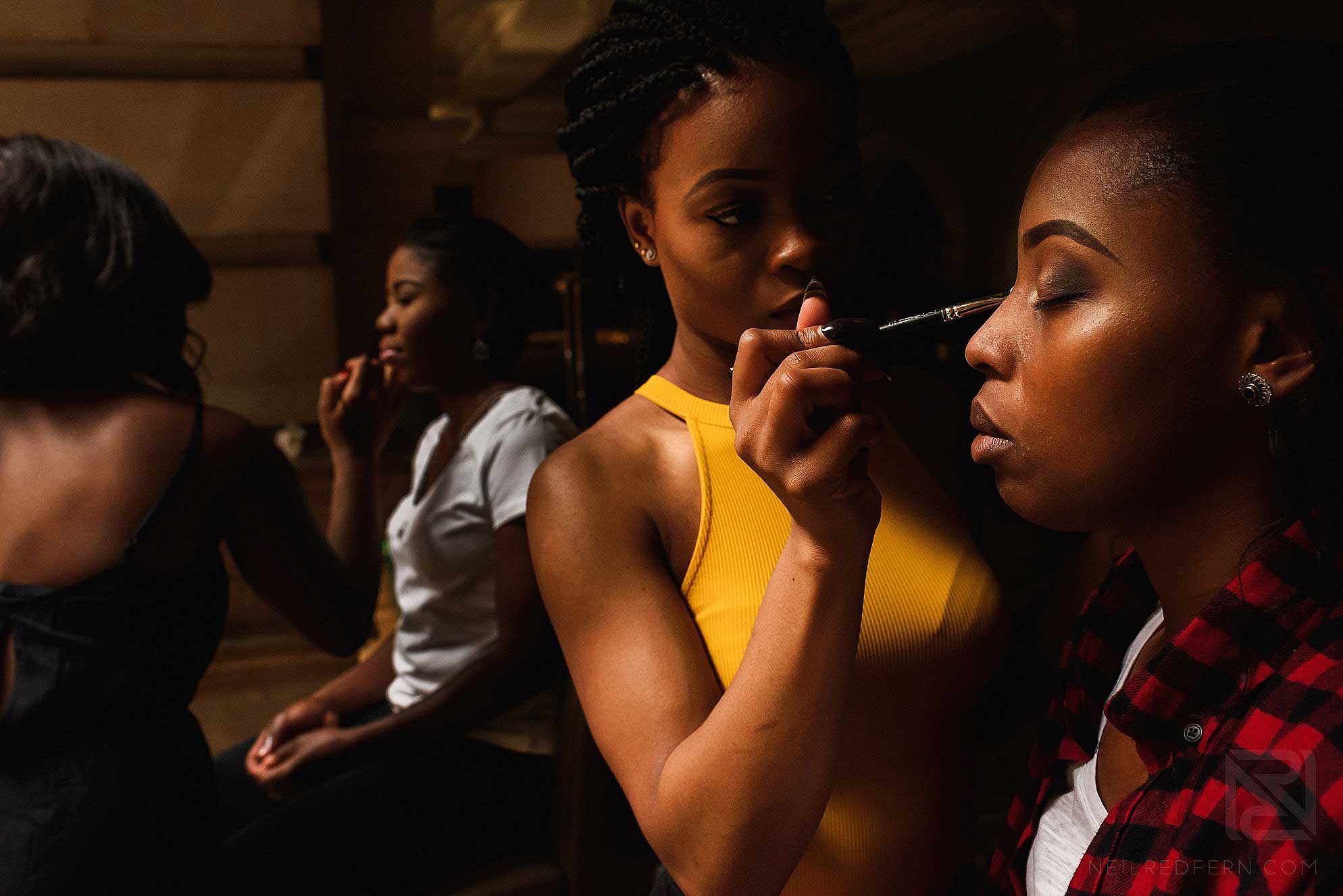 bridesmaids having make-up put on