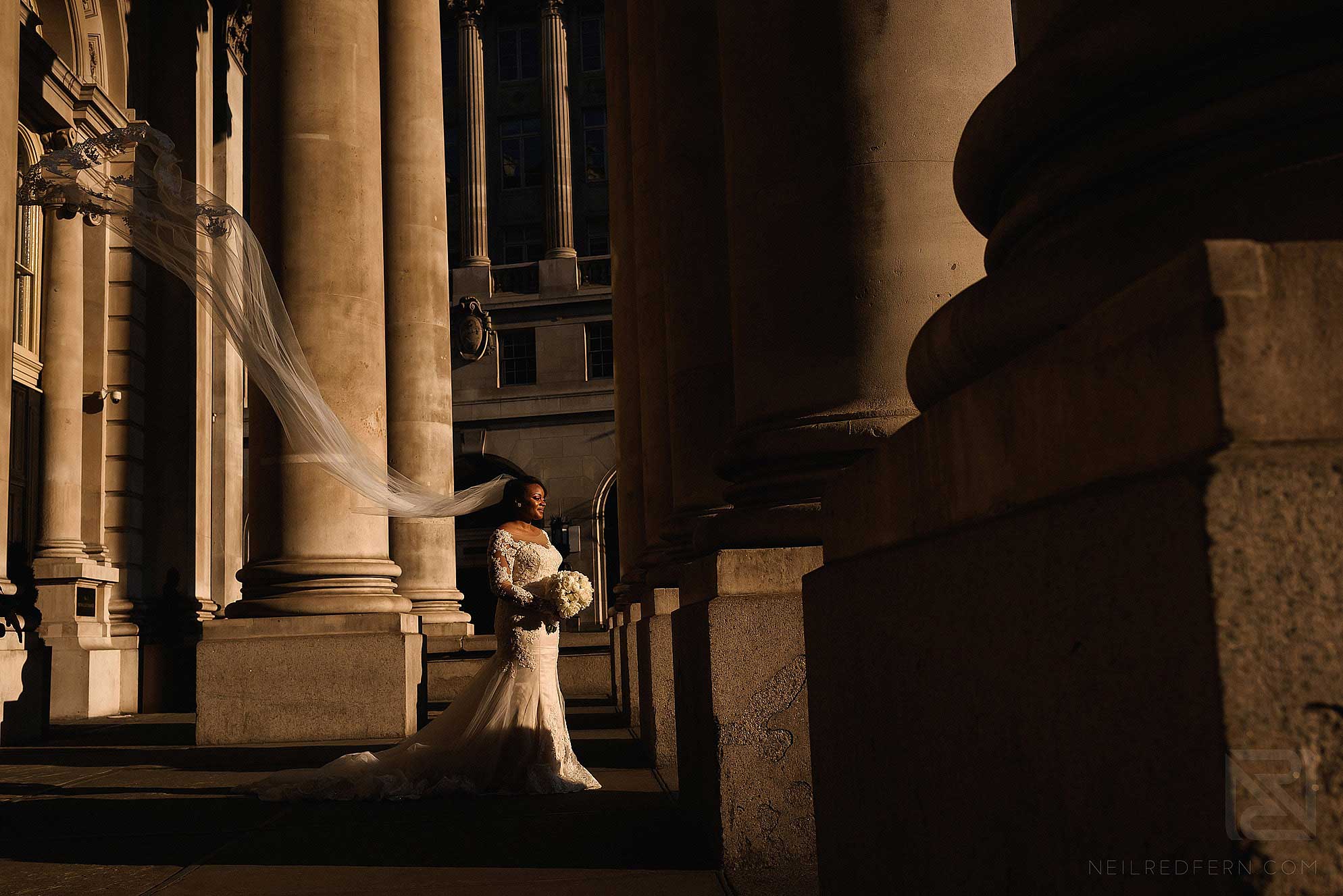 bride with long veil blowing in wind