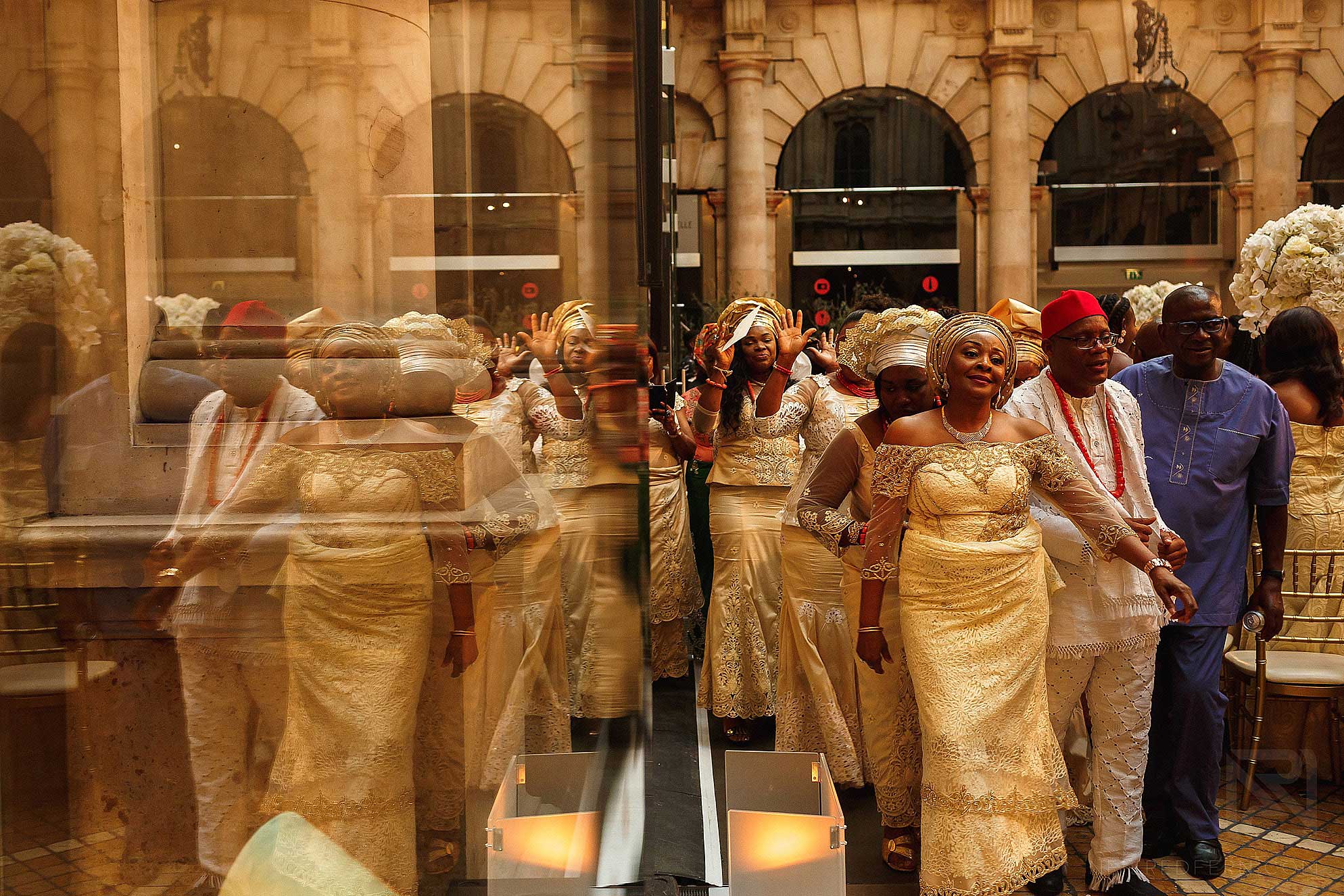 guests dancing in to Nigerian wedding