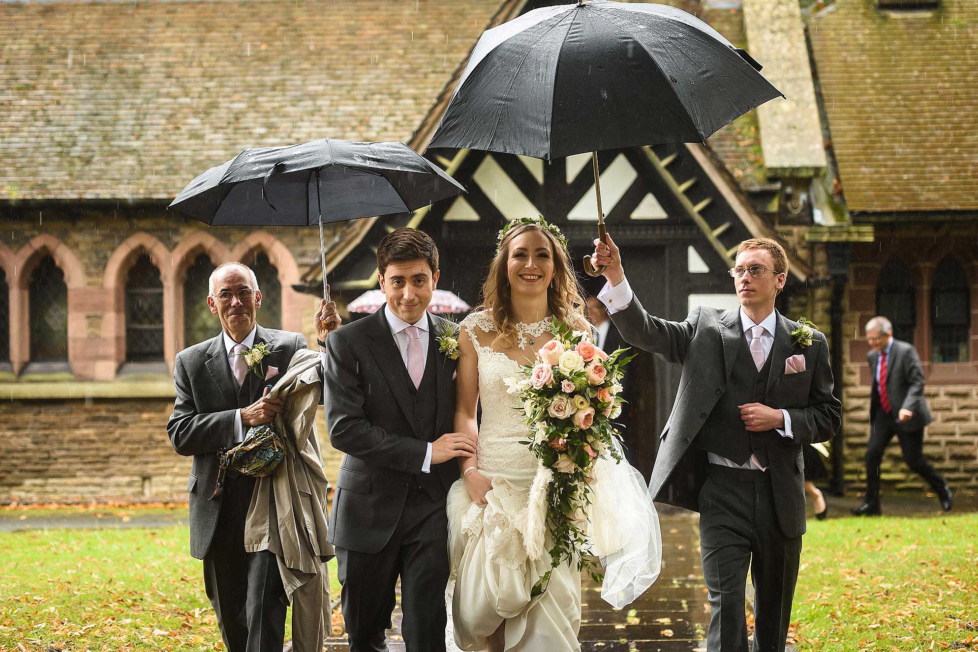 Abbeywood Estate wedding photography 13 bride and groom leaving church in rain