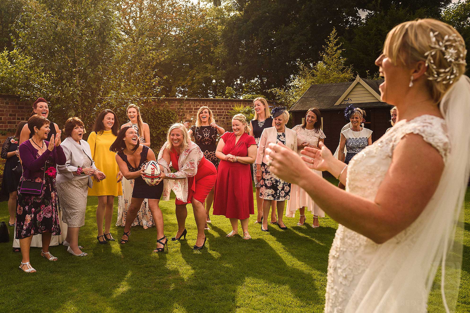bride throwing rugby ball
