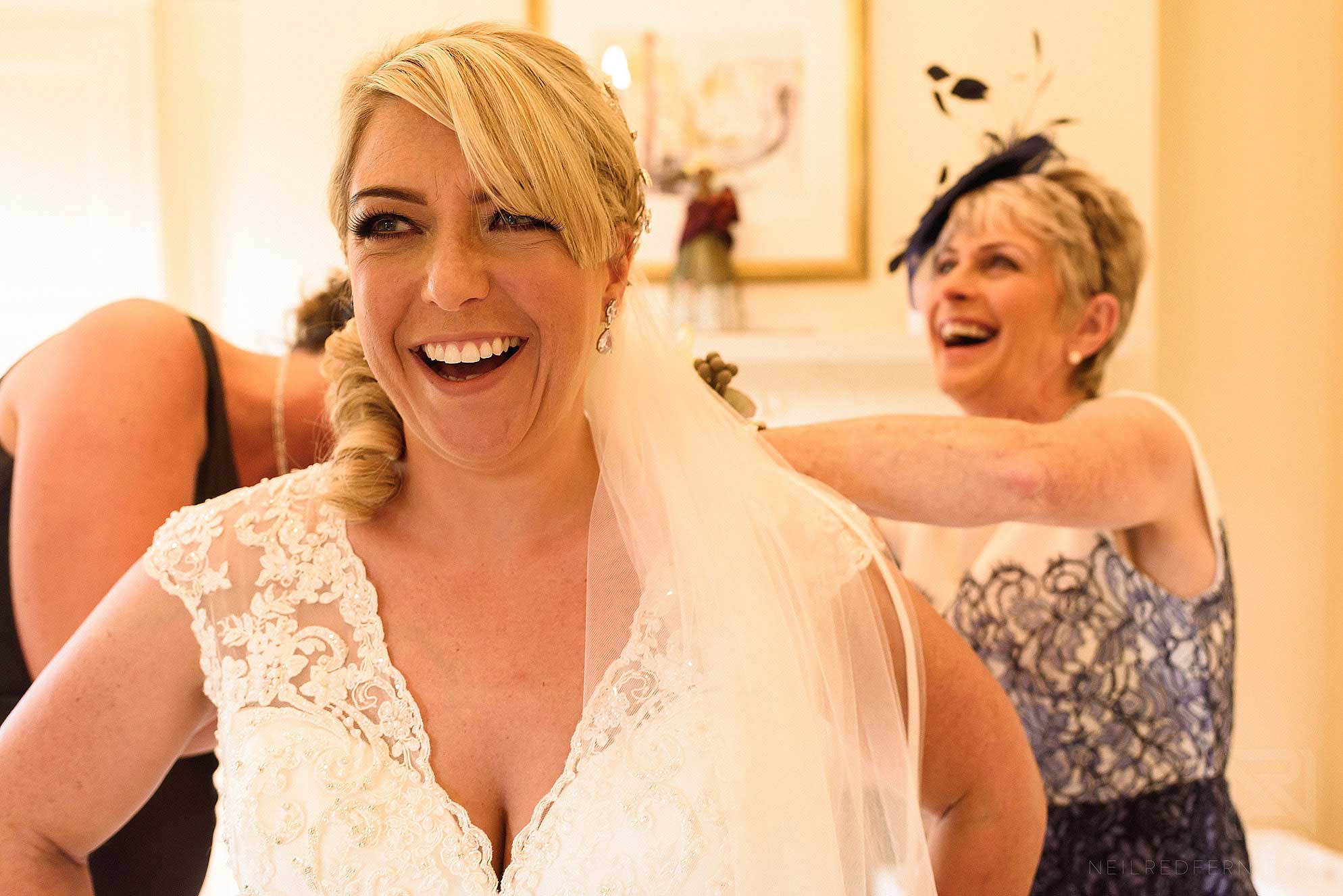 putting on the wedding dress