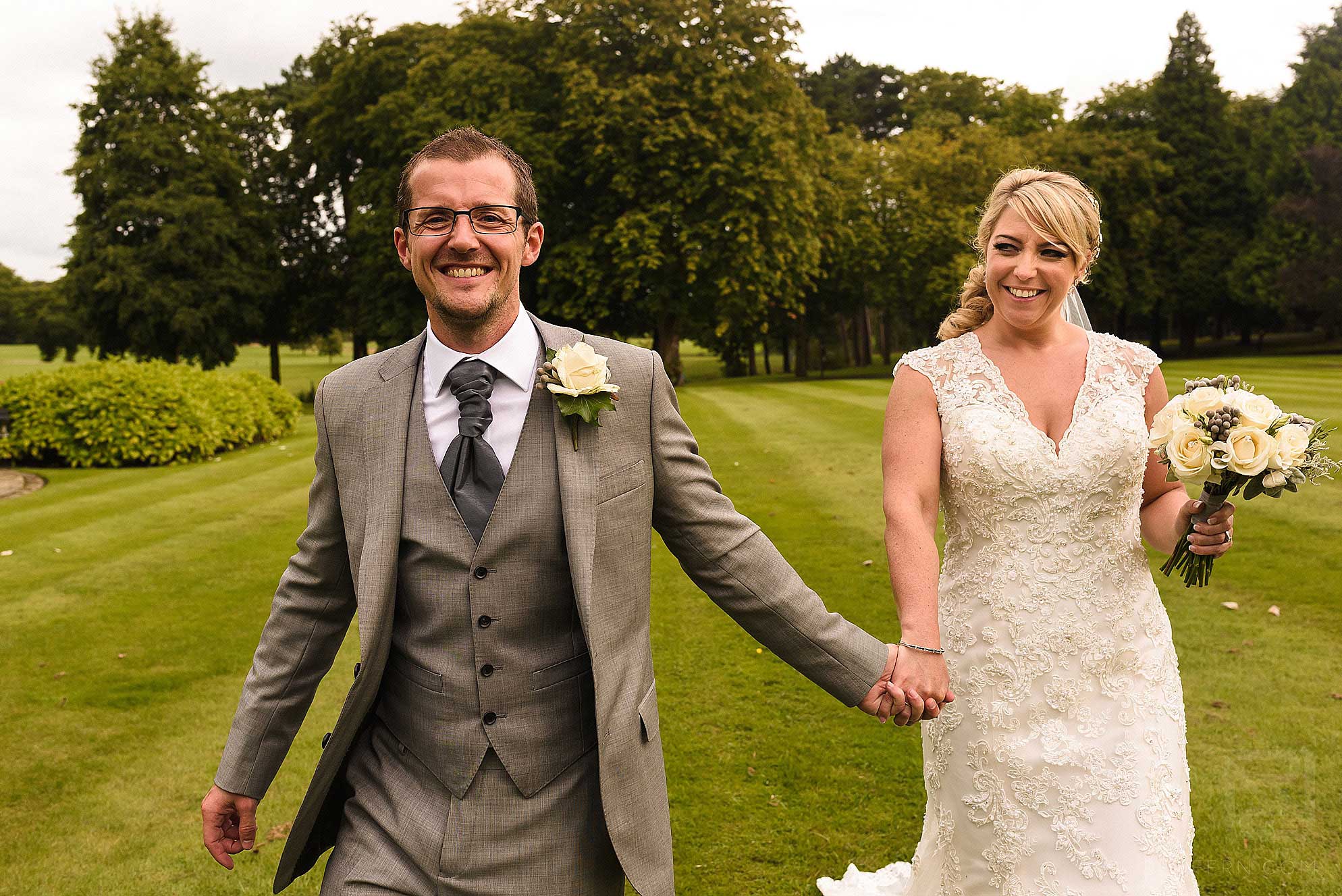bride and groom walking towards the camera