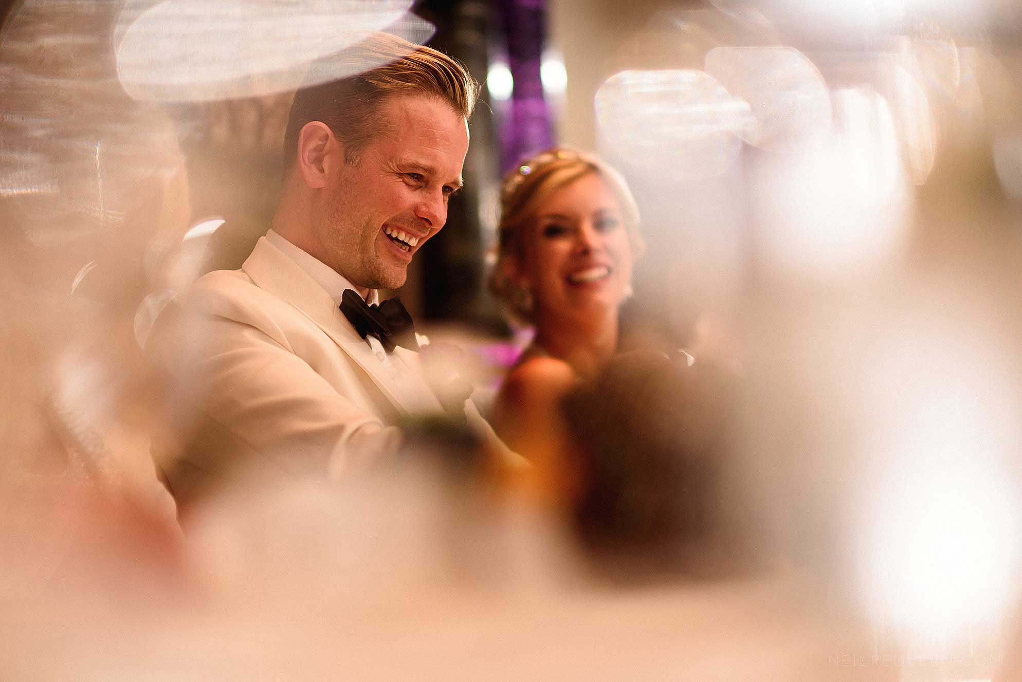 groom laughing during speeches
