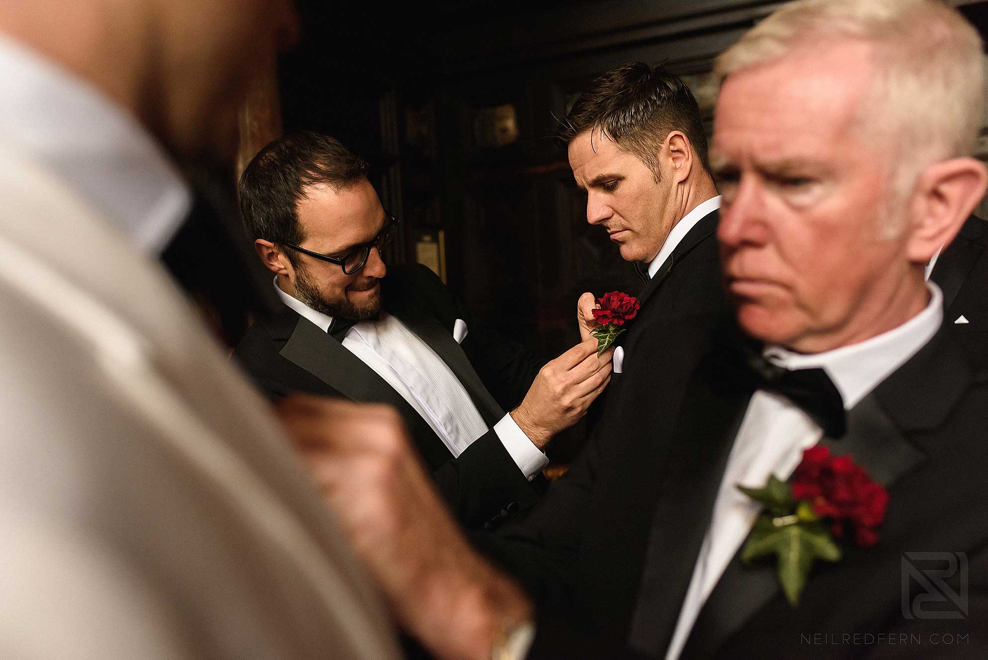 groomsmen putting on button holes