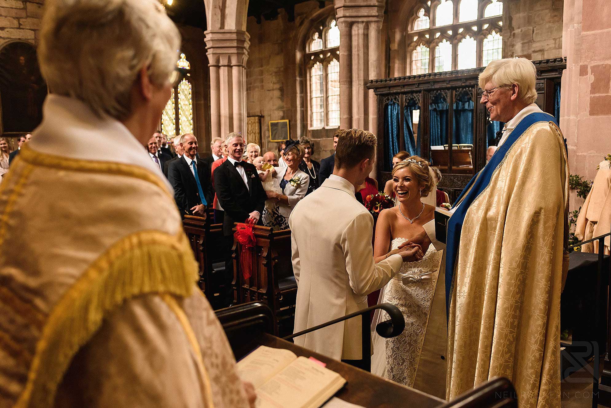 bride and groom laughing during wedding ceremony