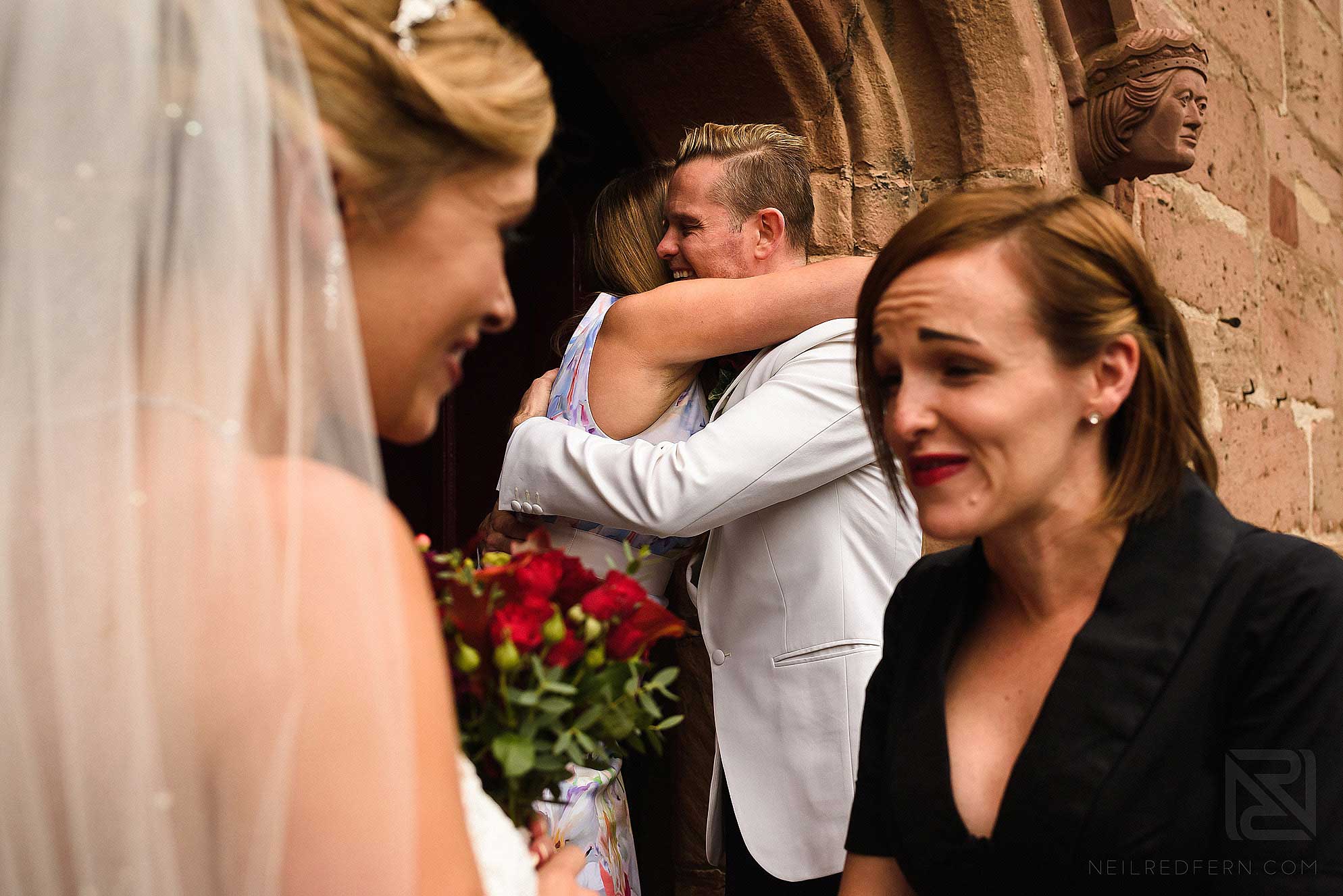 groom hugging friend at church
