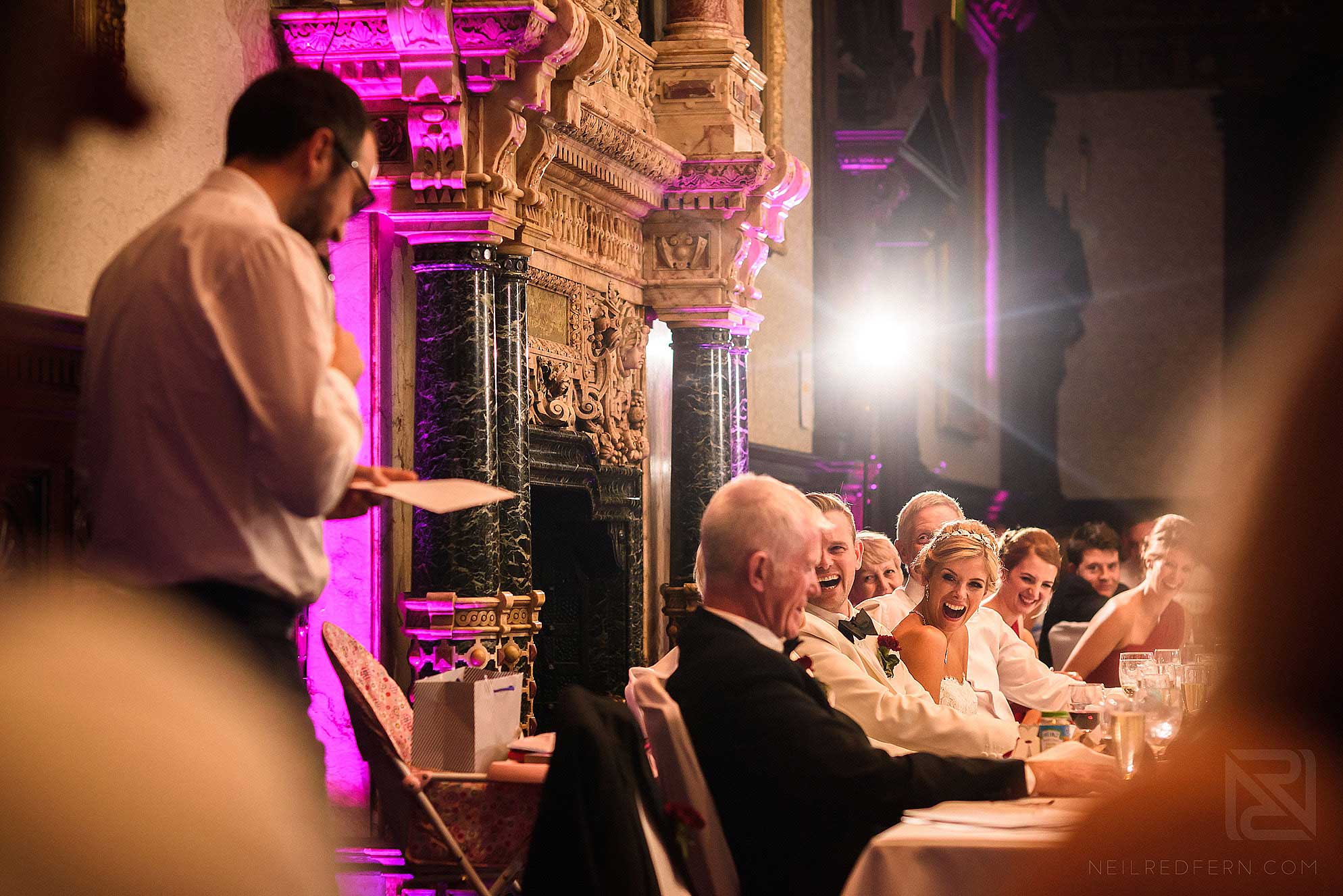 bride laughing during best man's speech