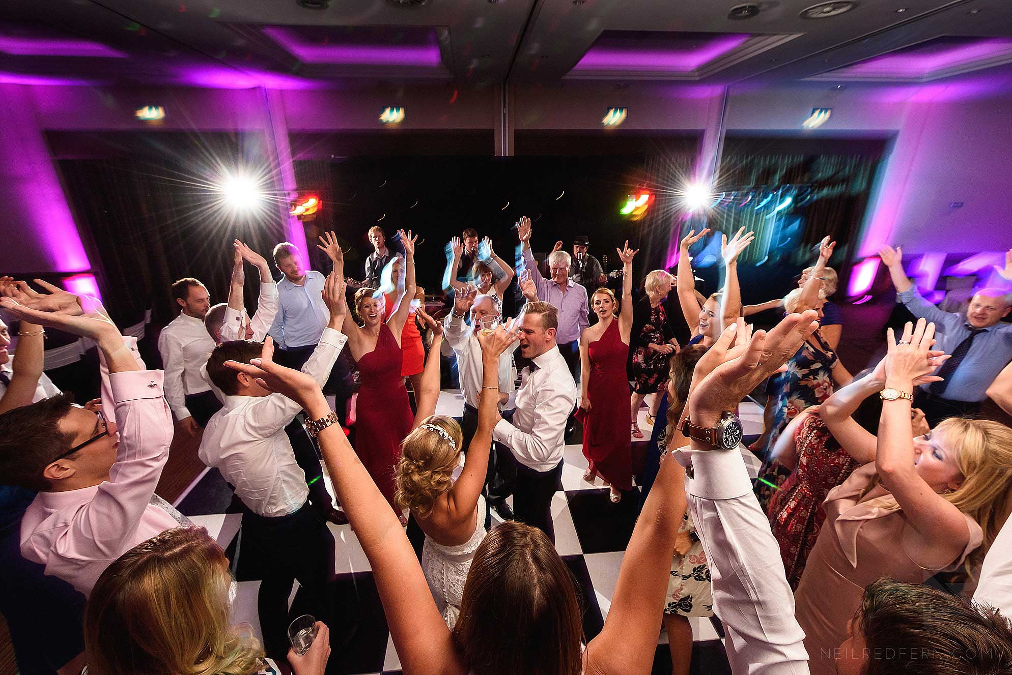 lots of wedding guests dancing
