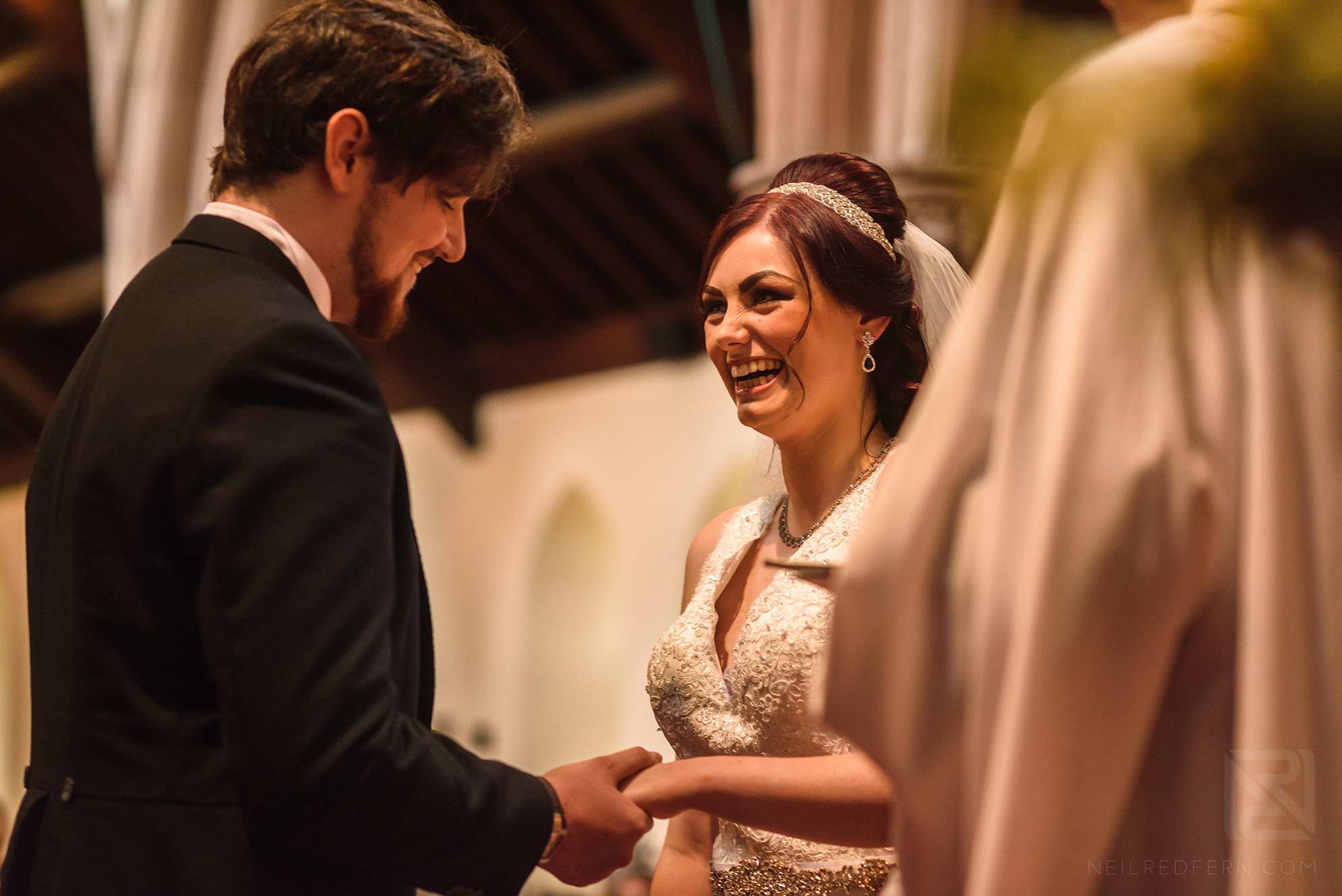Knowsley Hall summer wedding 2 bride laughing in church