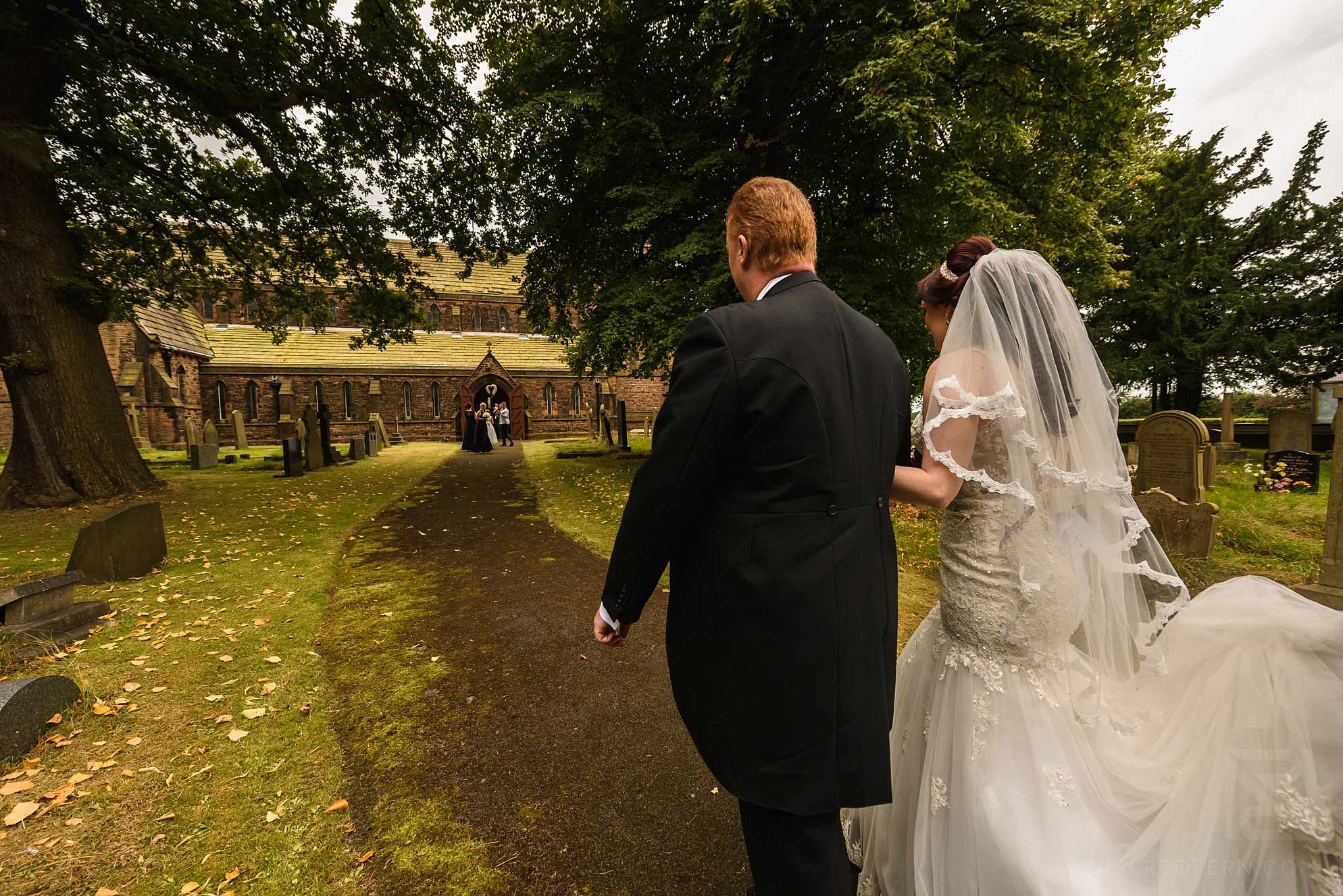 Knowsley Hall summer wedding 8 bride and father walking to church
