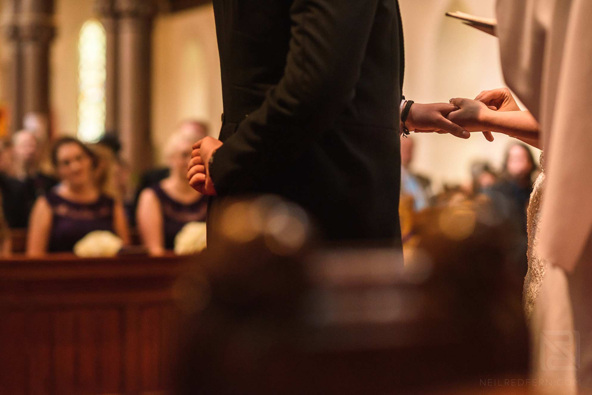 Knowsley Hall summer wedding 12 bride putting ring on groom