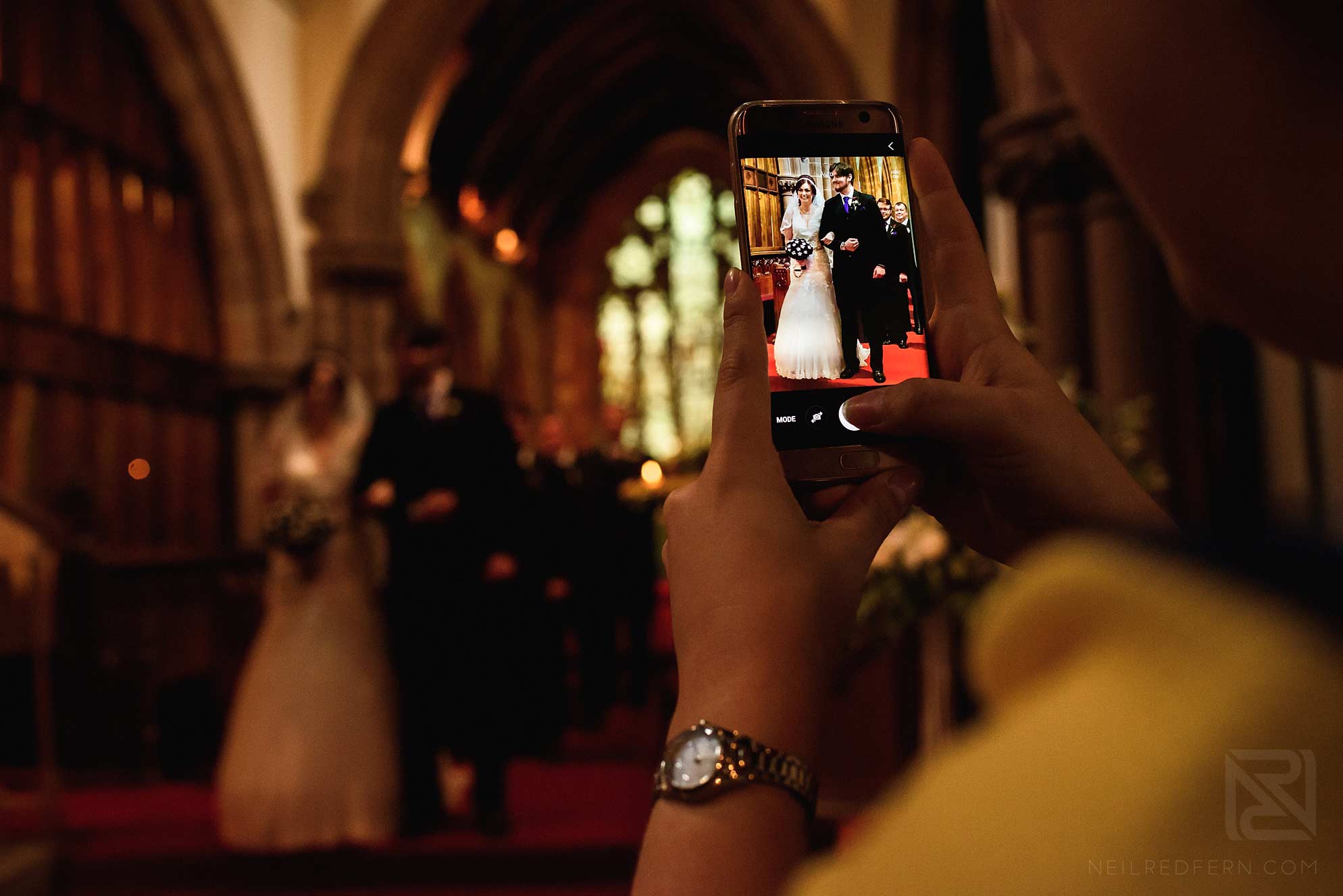 Knowsley Hall summer wedding 13 wedding guest taking photograph on phone