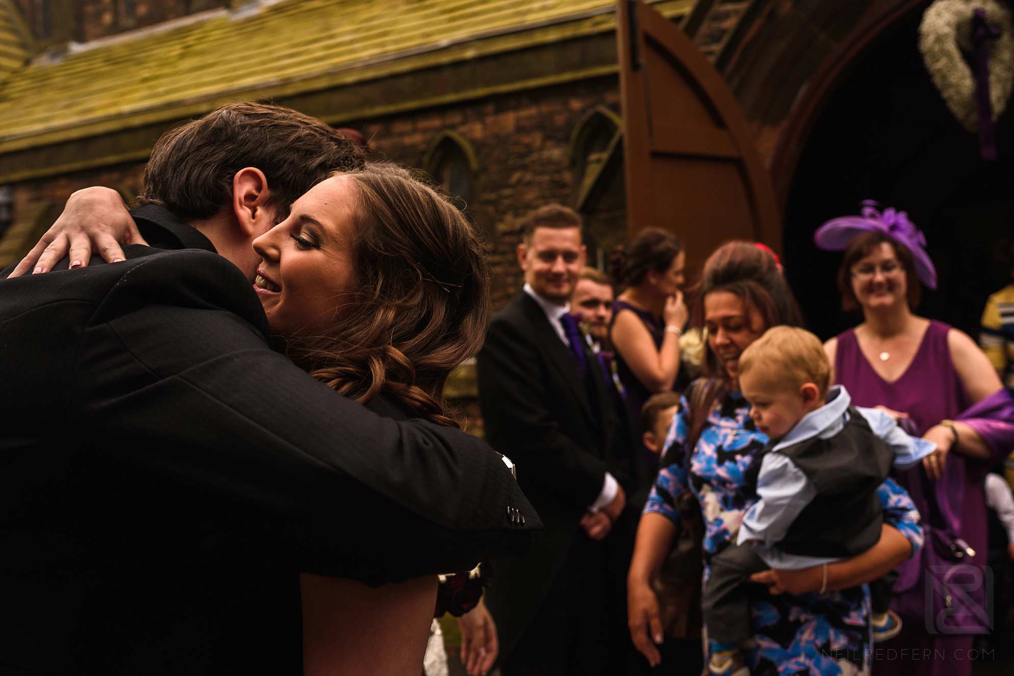 Knowsley Hall summer wedding 14 wedding guests hugging