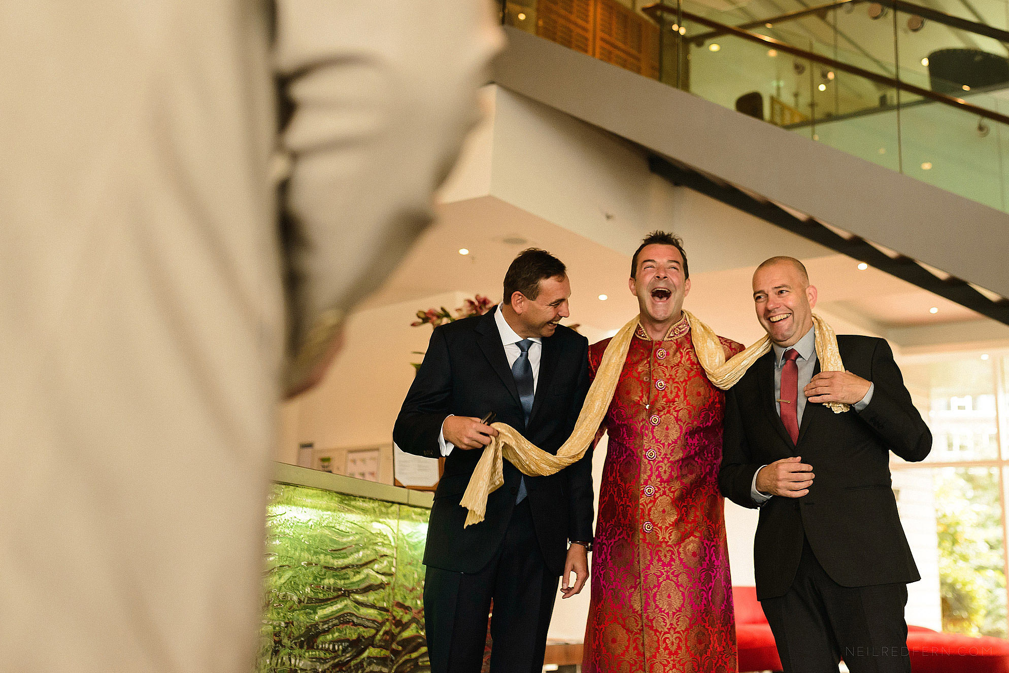 groom laughing with friends