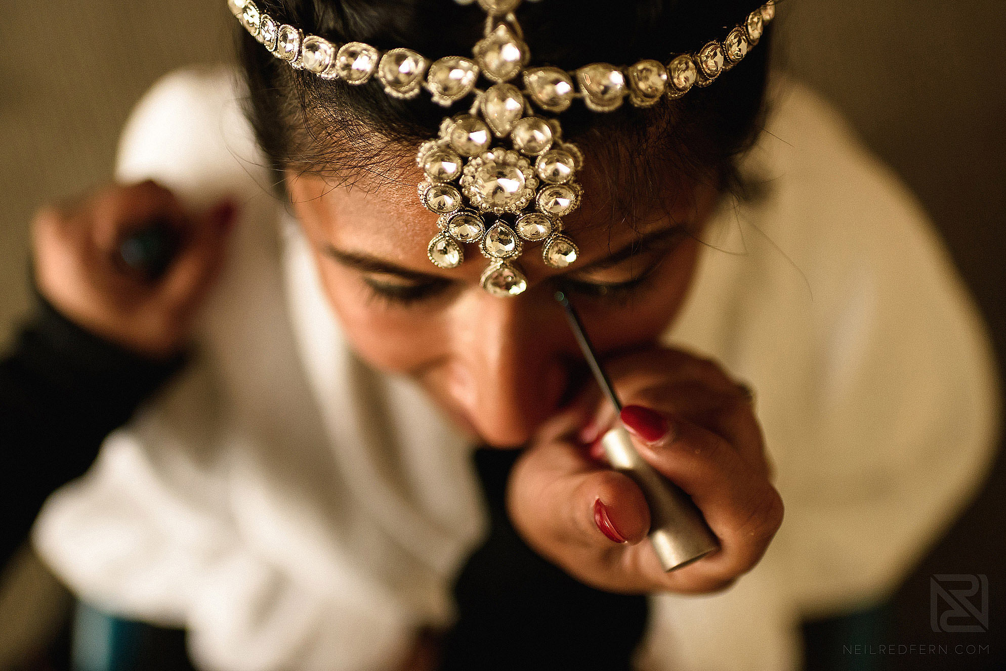Hindu bride putting on make-up