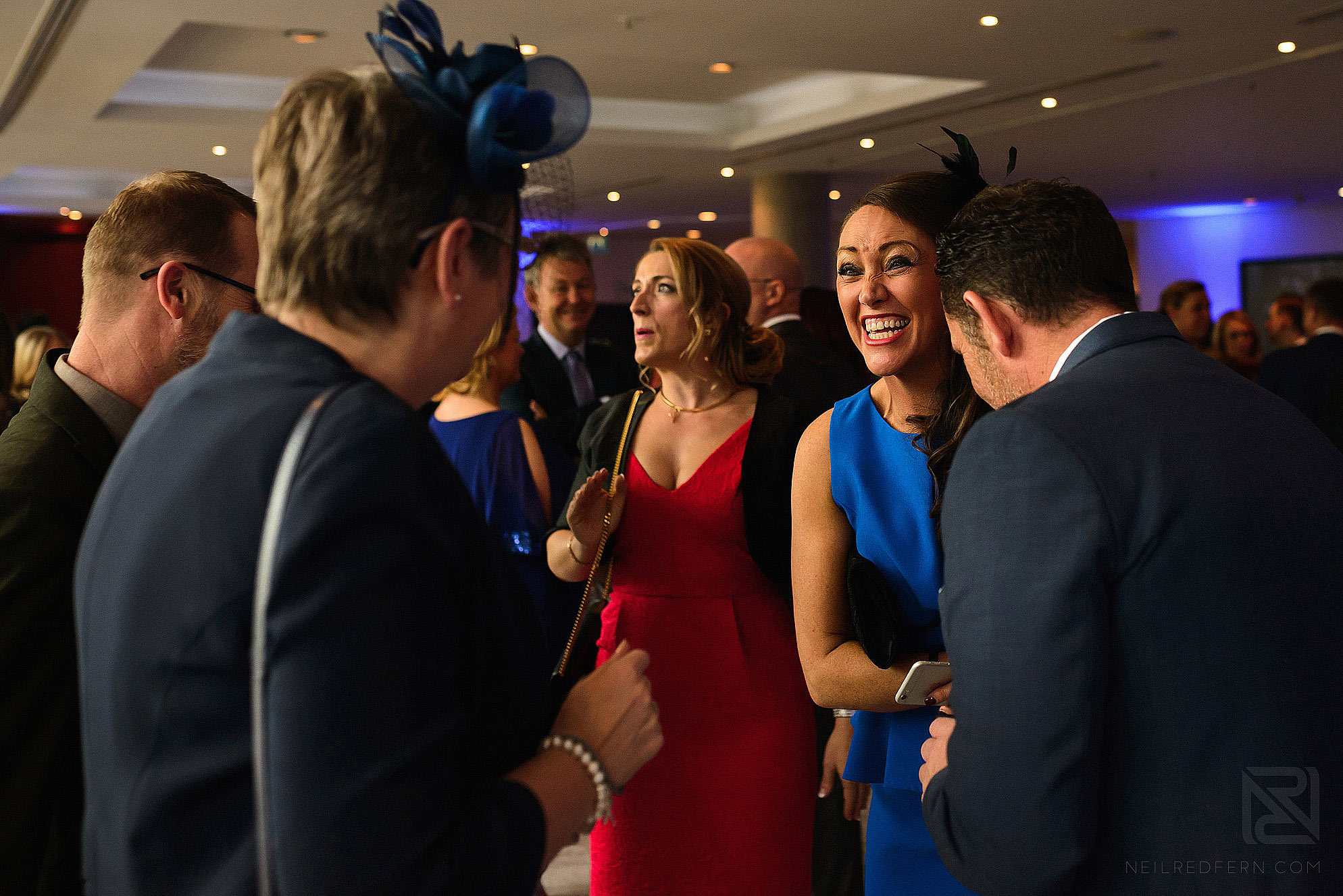 wedding guests laughing during drinks reception