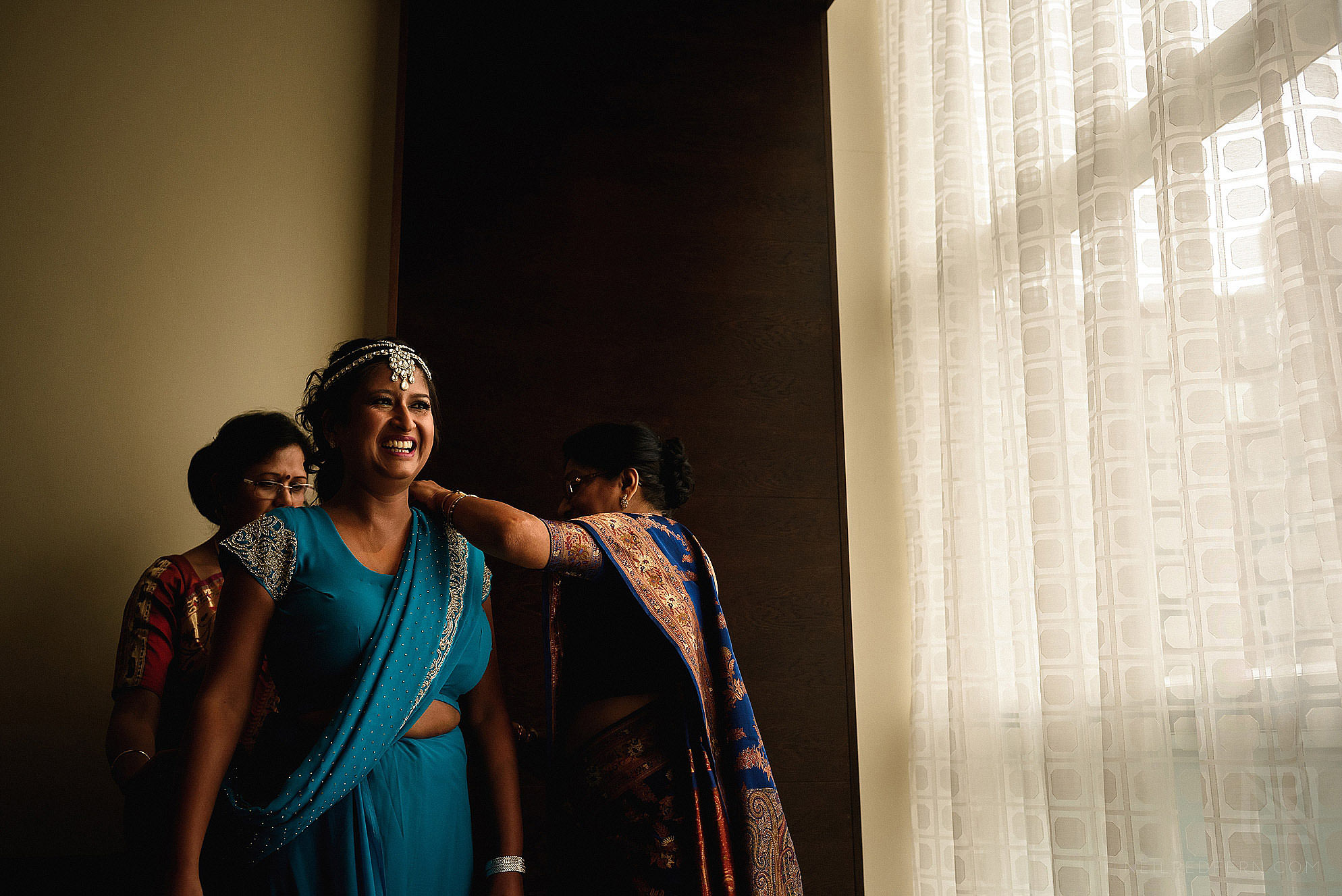 Hindu bride putting on dress