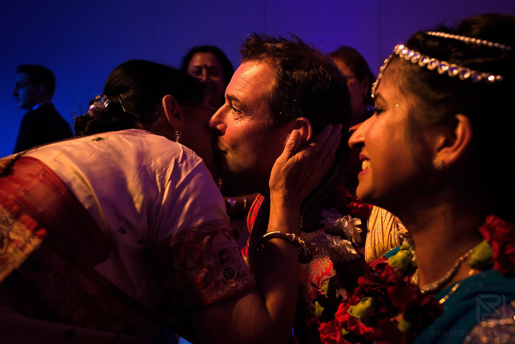 groom kissing guest during ceremony