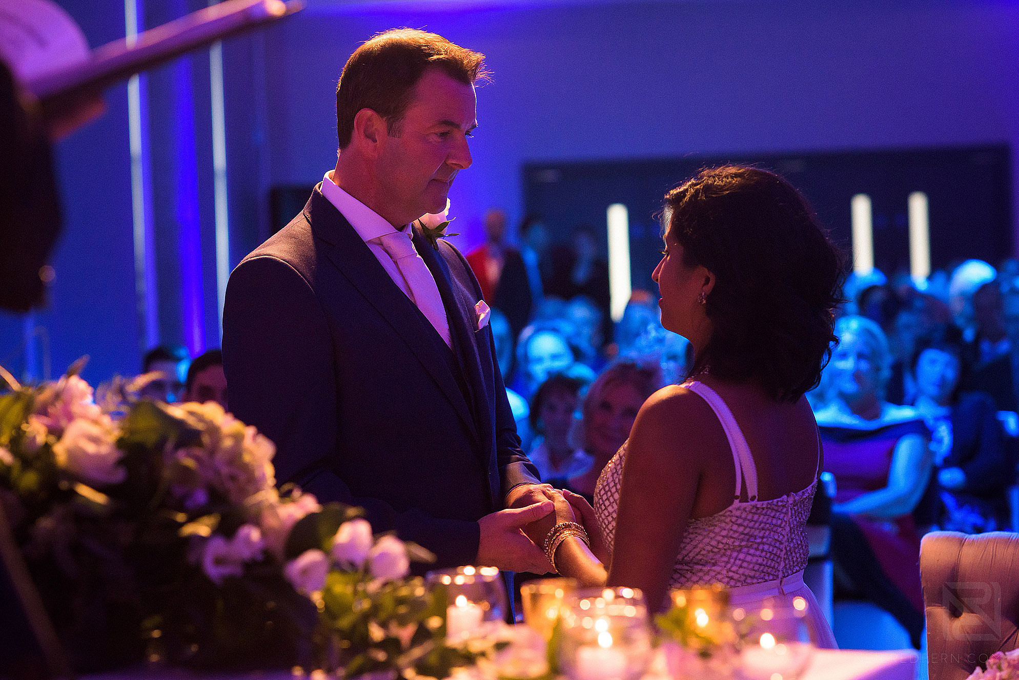 exchanging vows during wedding ceremony at The Lowry Hotel in Manchester
