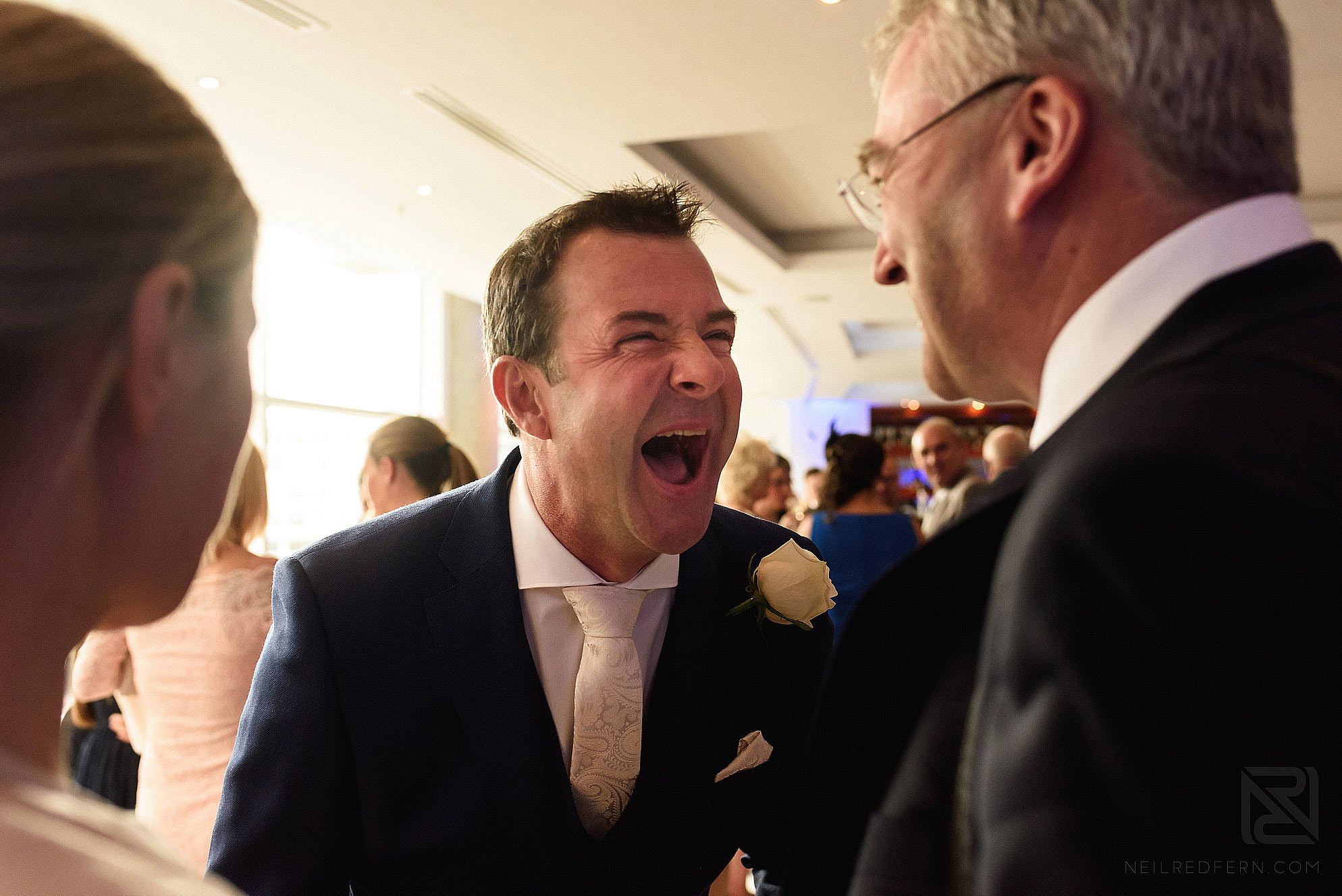 groom laughing with friends