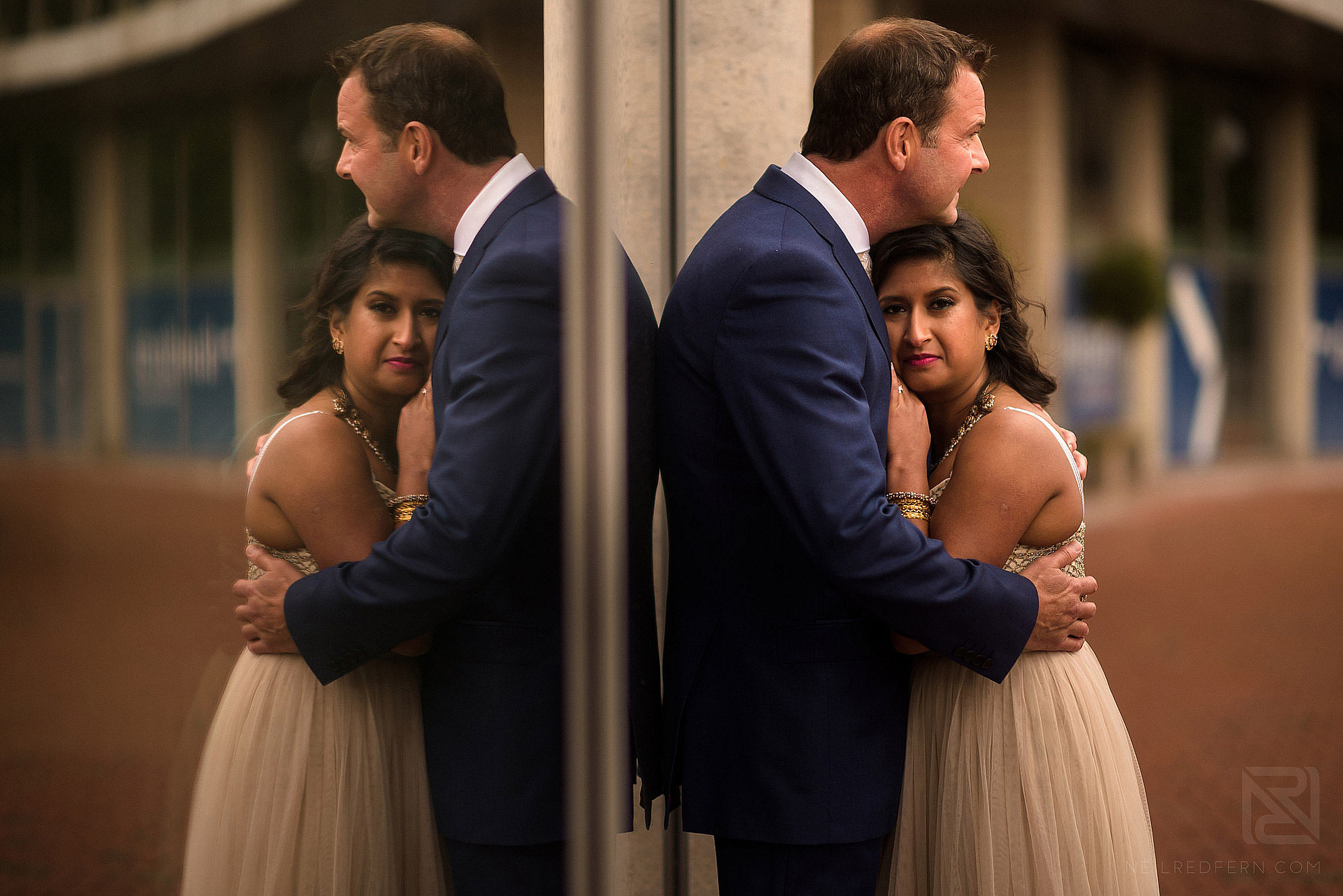 bride and groom reflection in window