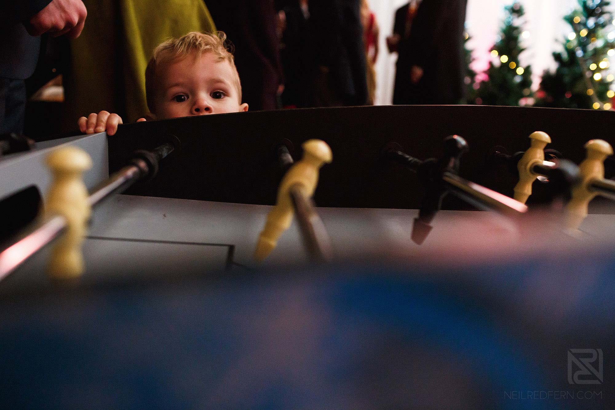 little boy play air hockey at wedding