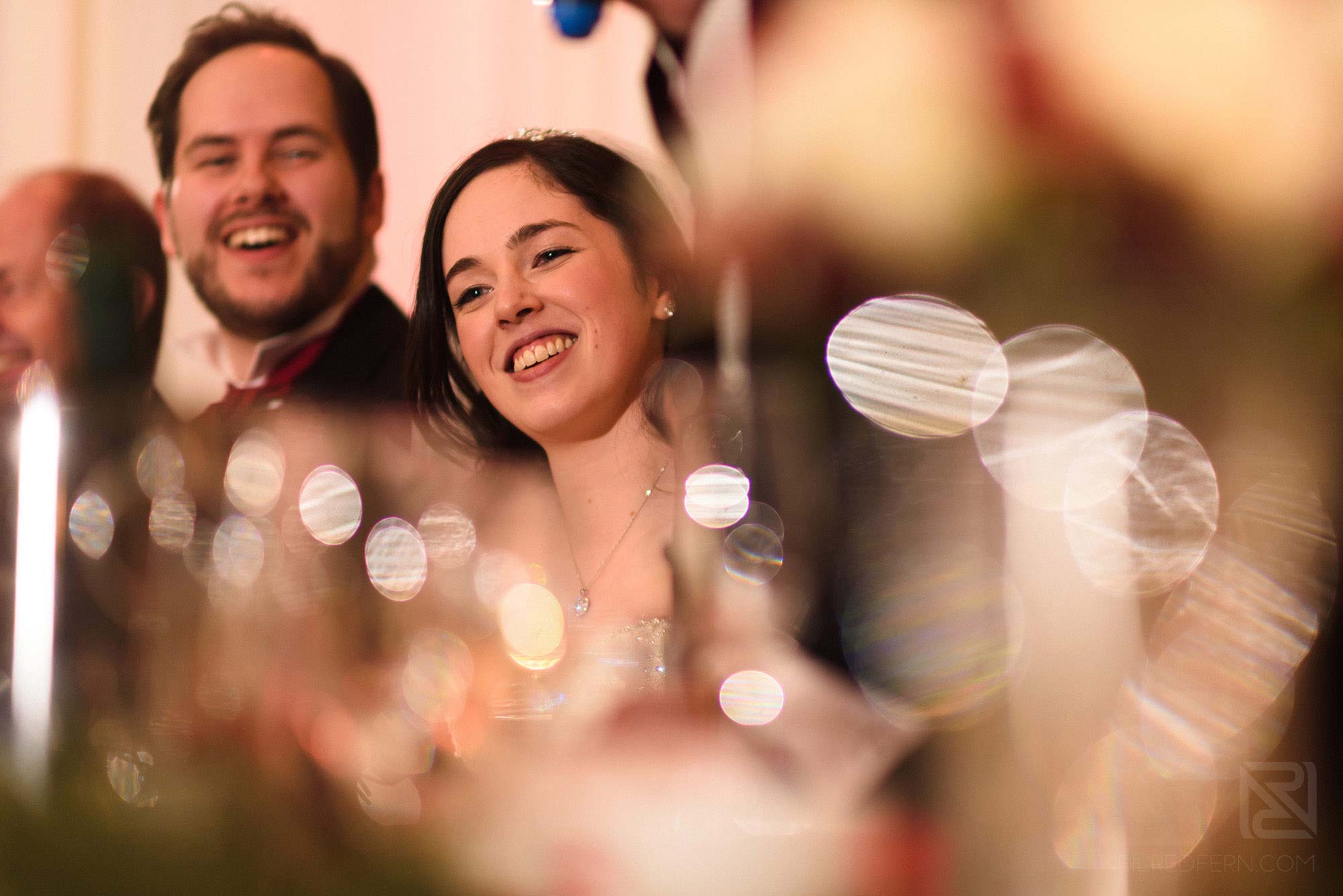 bride smiling during wedding speeches