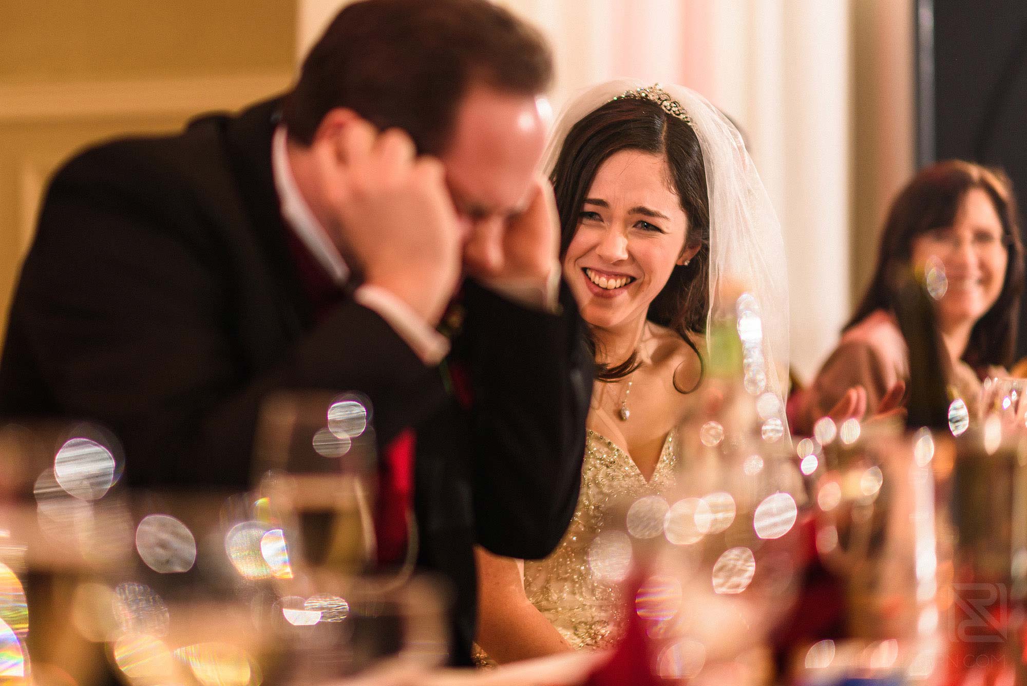 groom putting fingers in ears during Best Man's speech