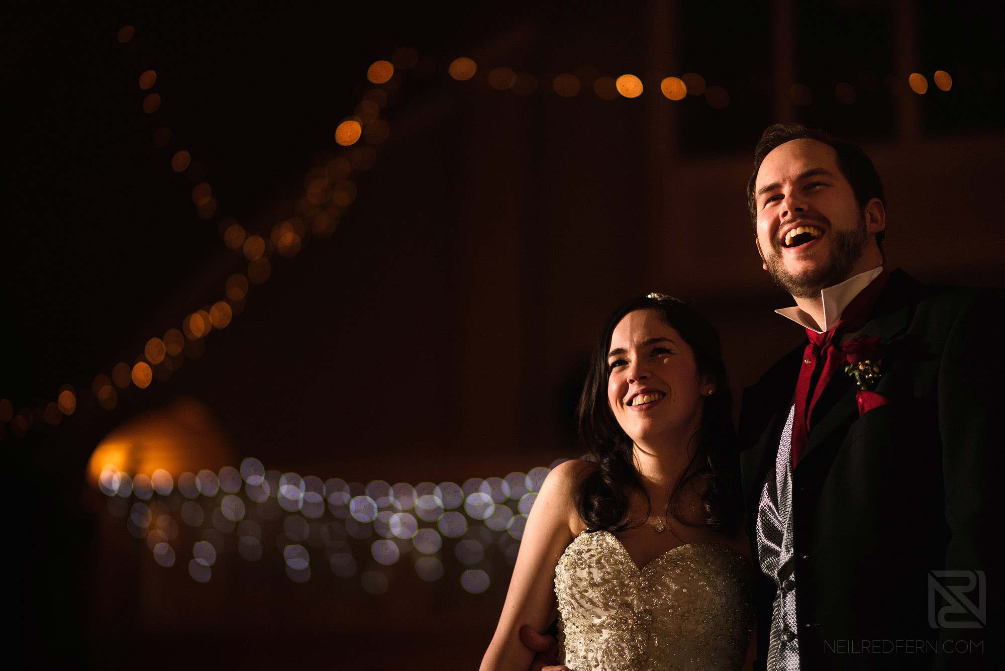 bride and groom laughing during wedding reception