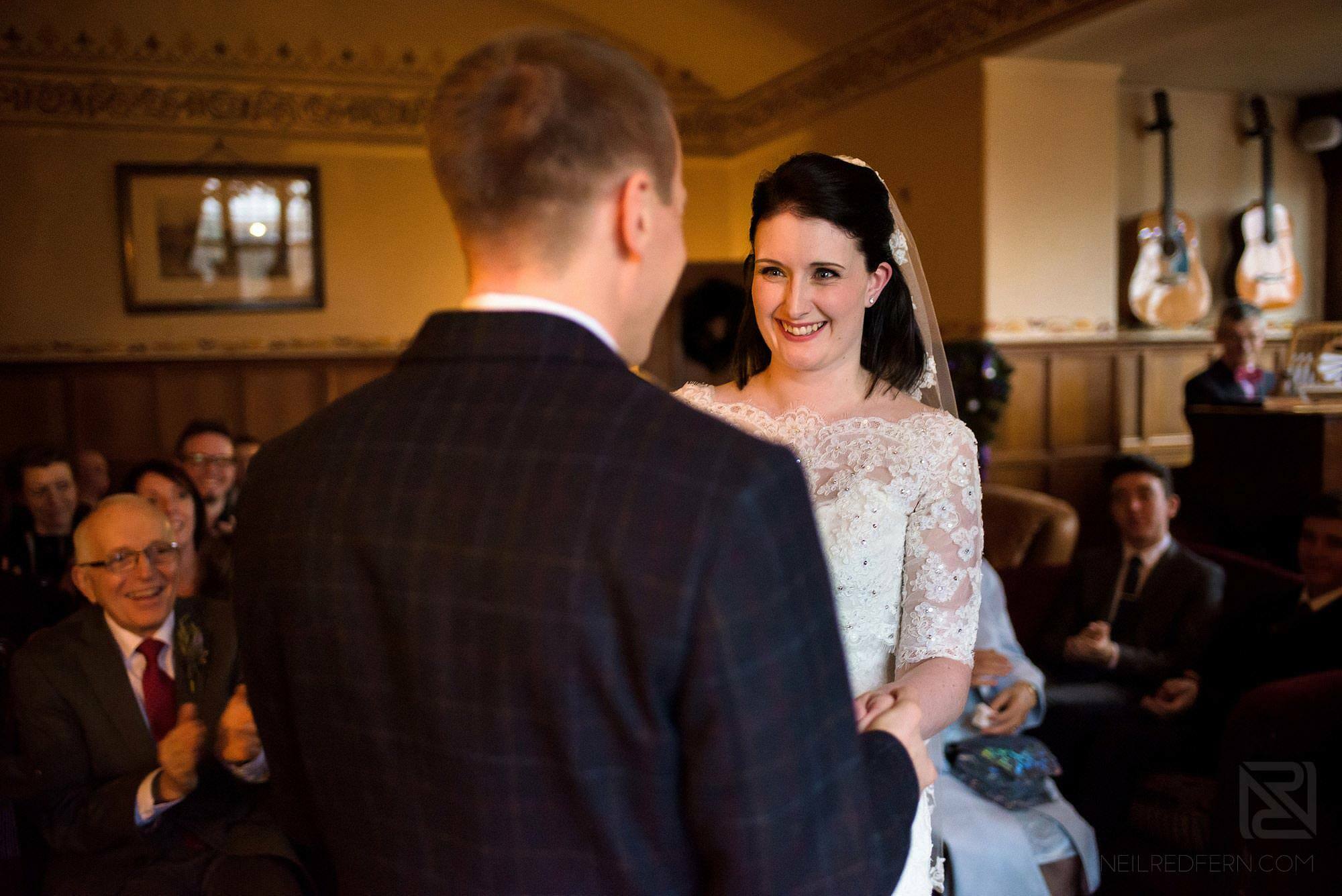 bride and groom saying vows during wedding ceremony