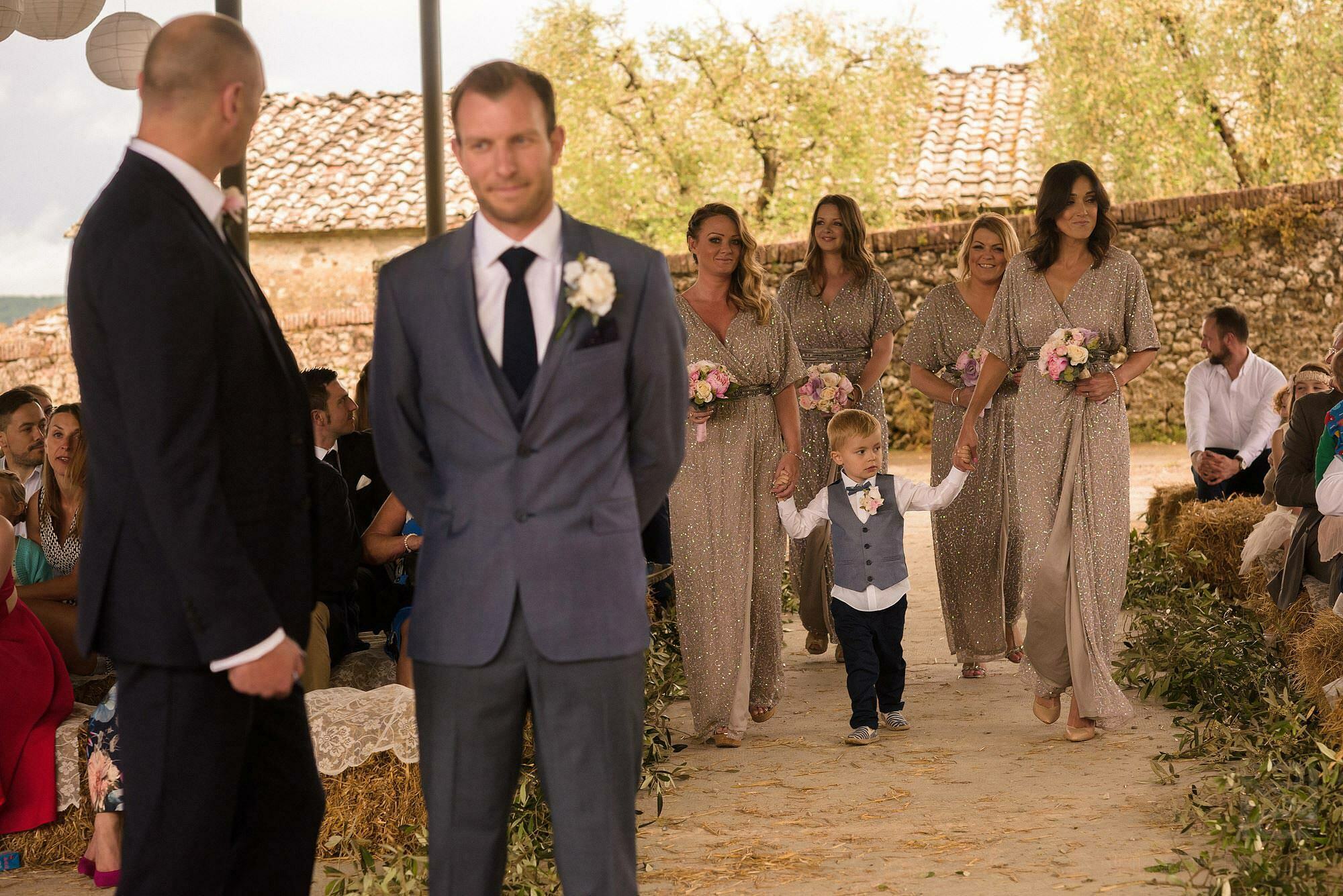 bridesmaids walking down aisle in Tuscany