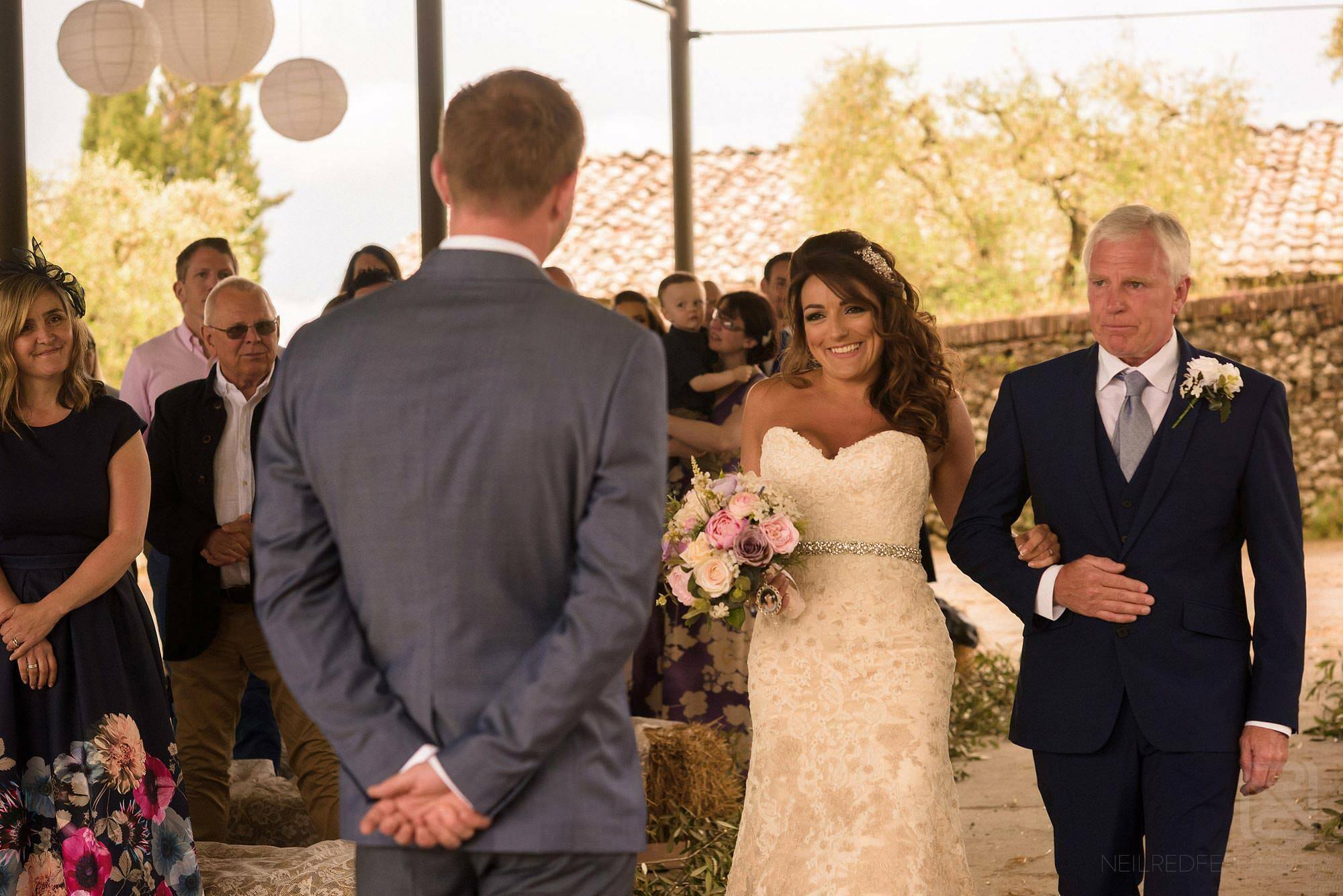 bride walking down aisle in Tuscany