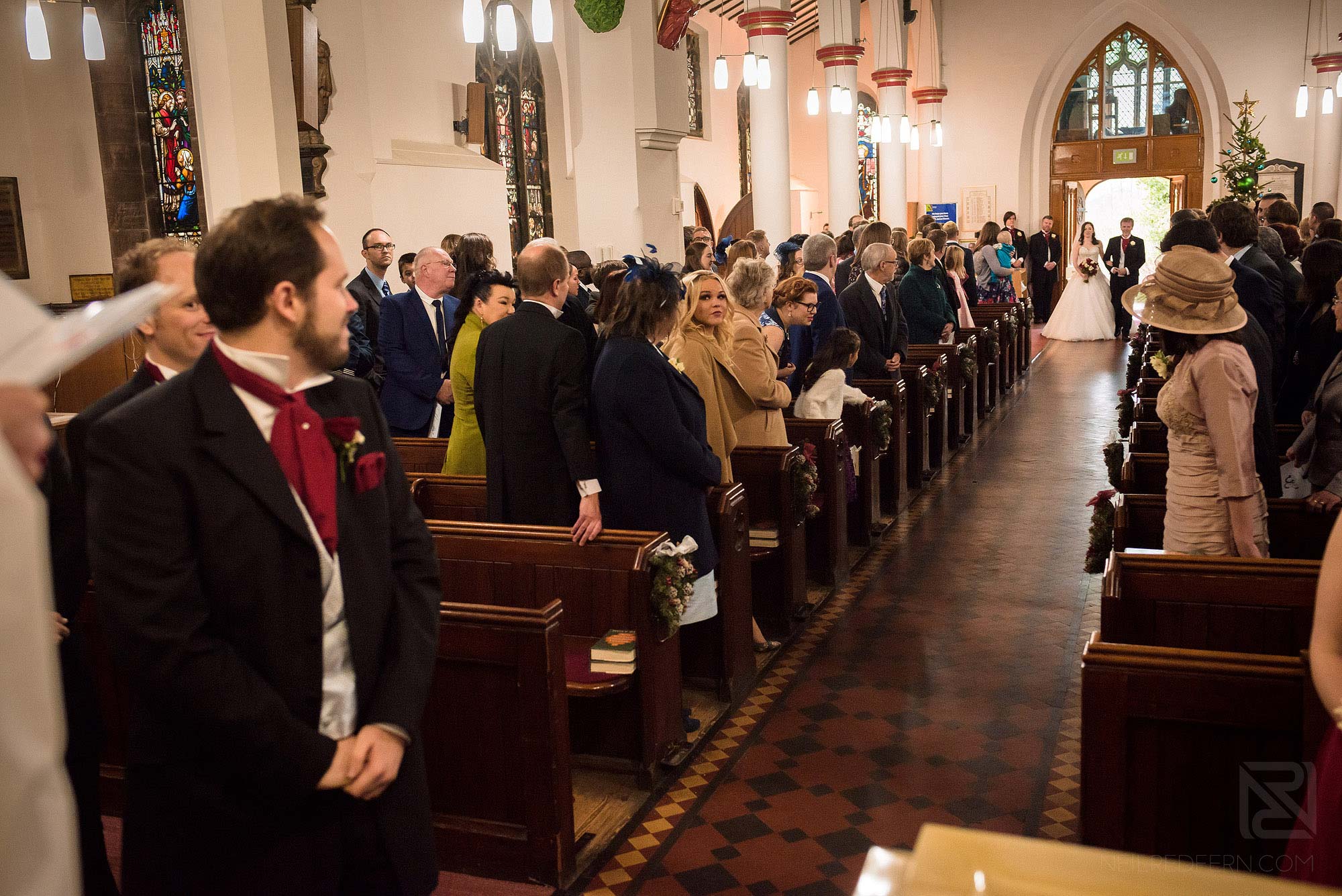 bride walking down aisle in St James' Church in Didsbury
