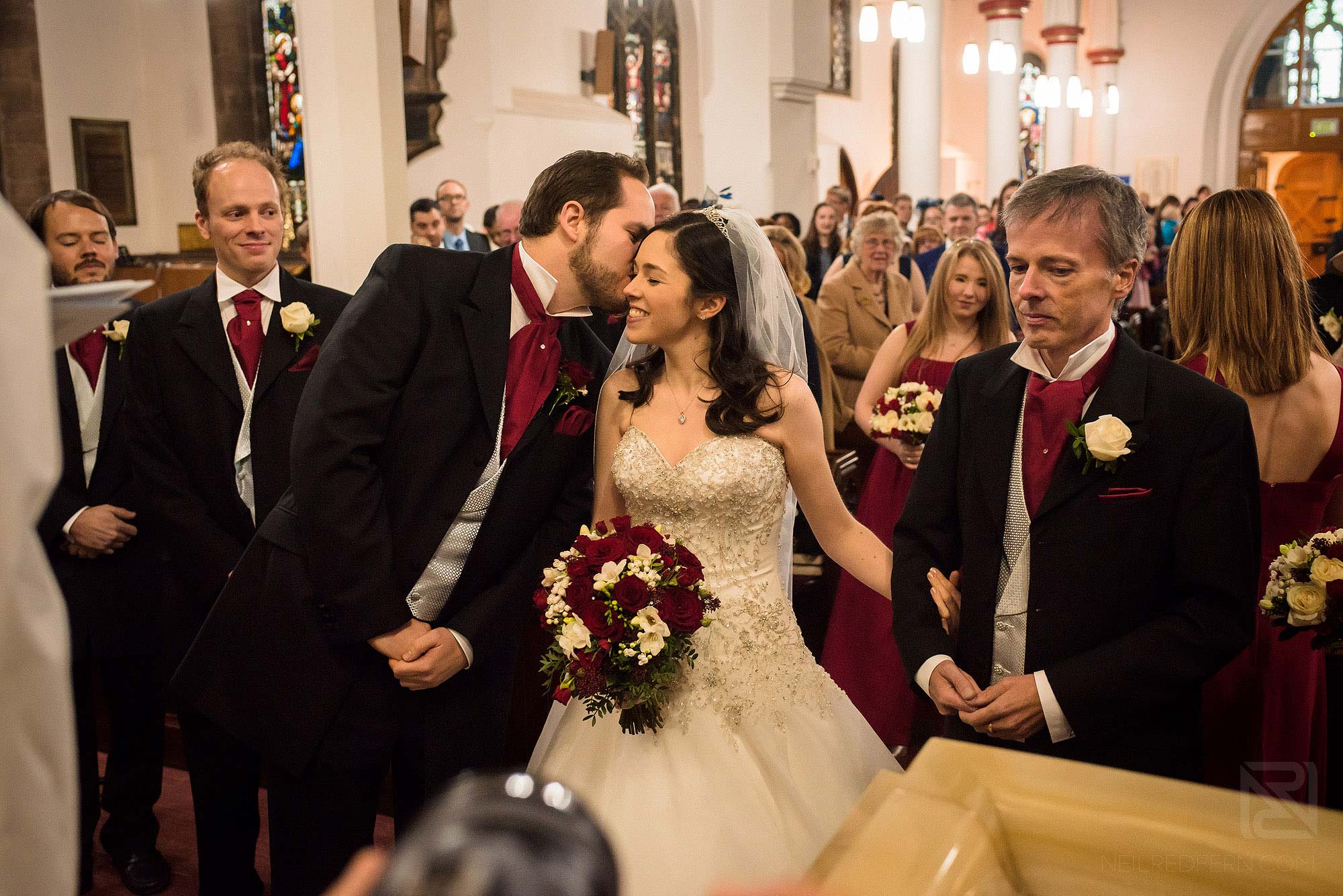 groom kissing bride during wedding ceremony