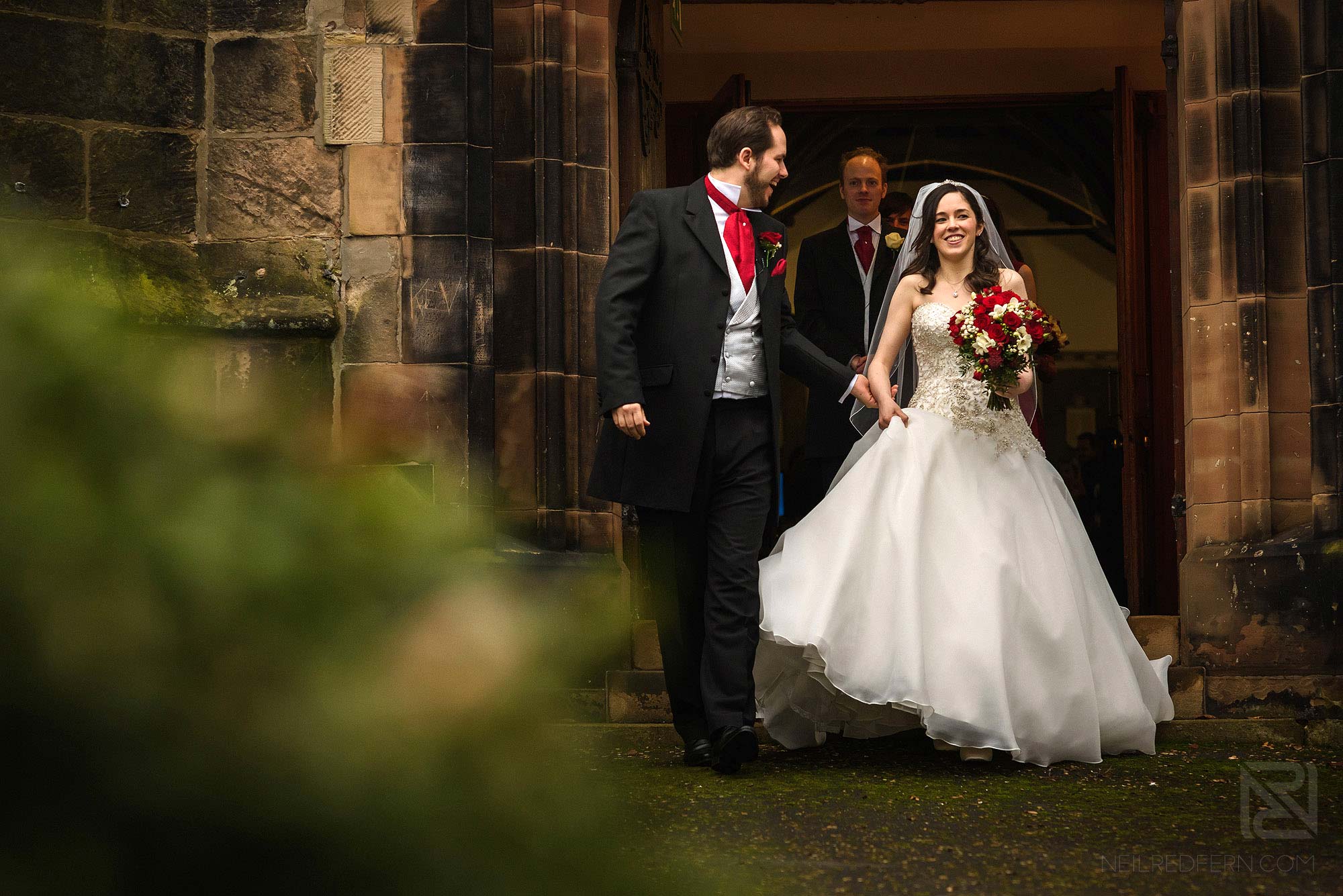 bride and groom leaving church together
