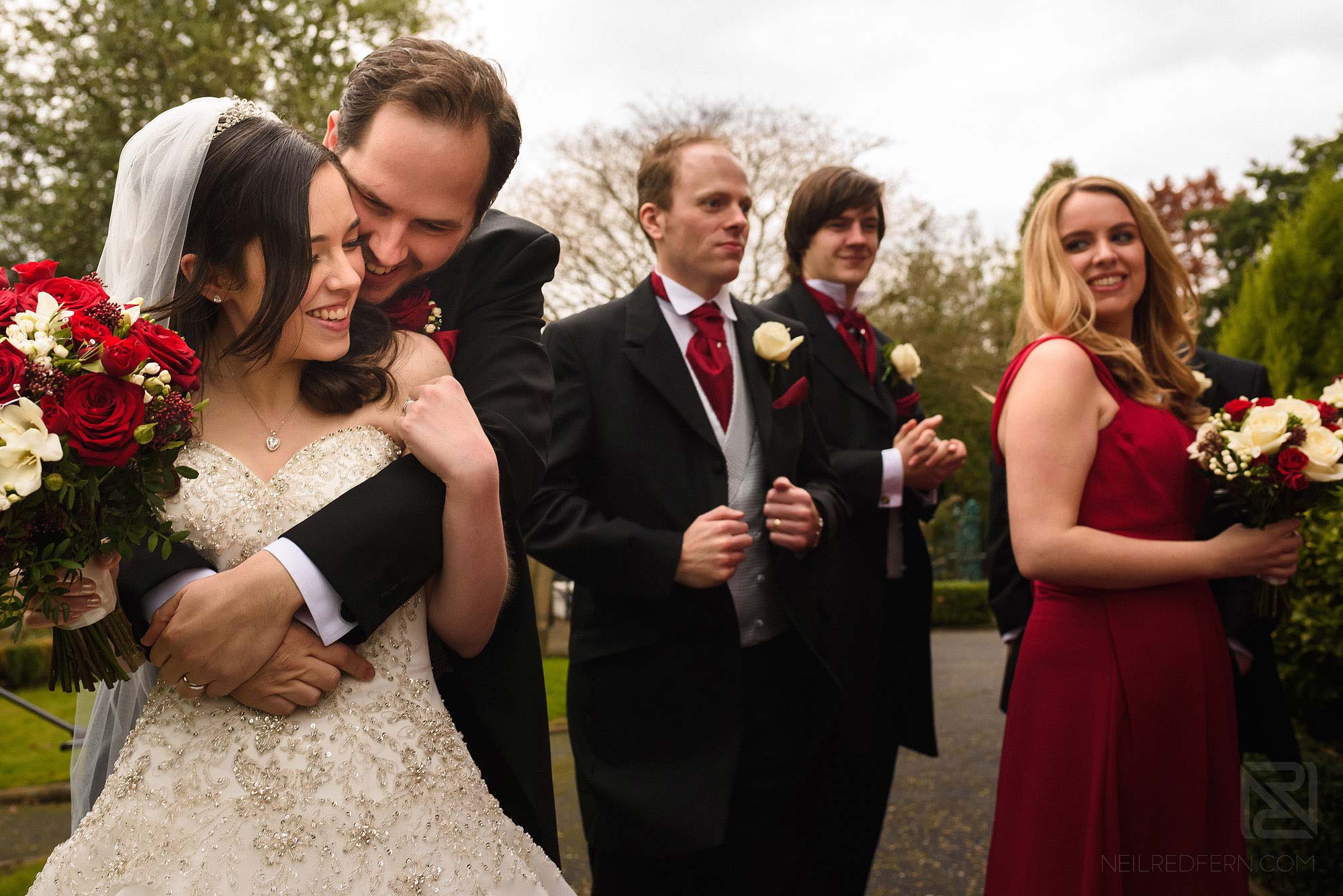 groom hugging bride outside church