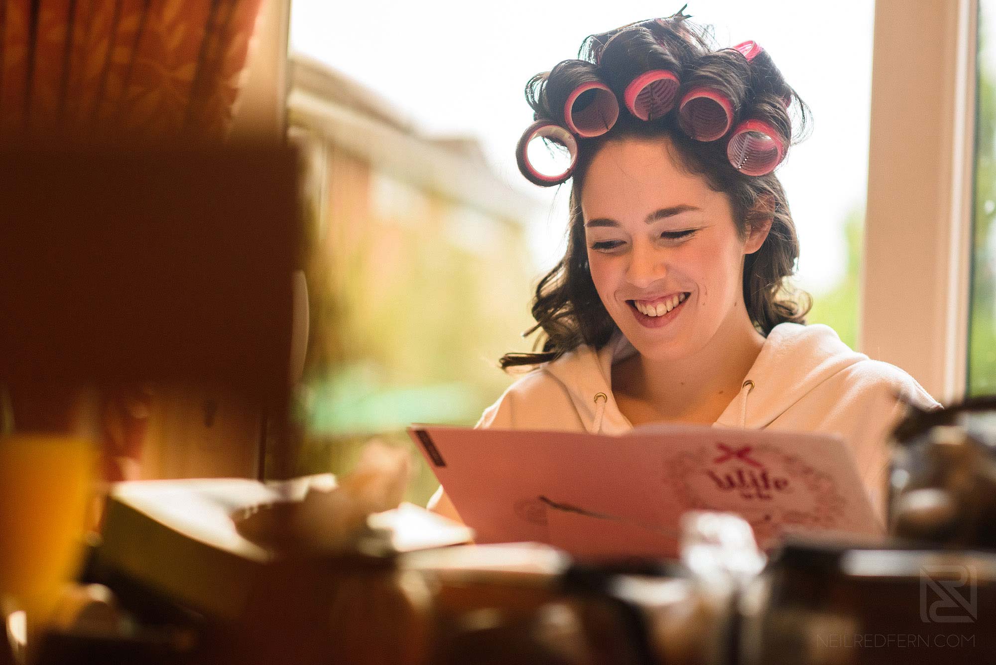 bride reading card from groom on morning of wedding