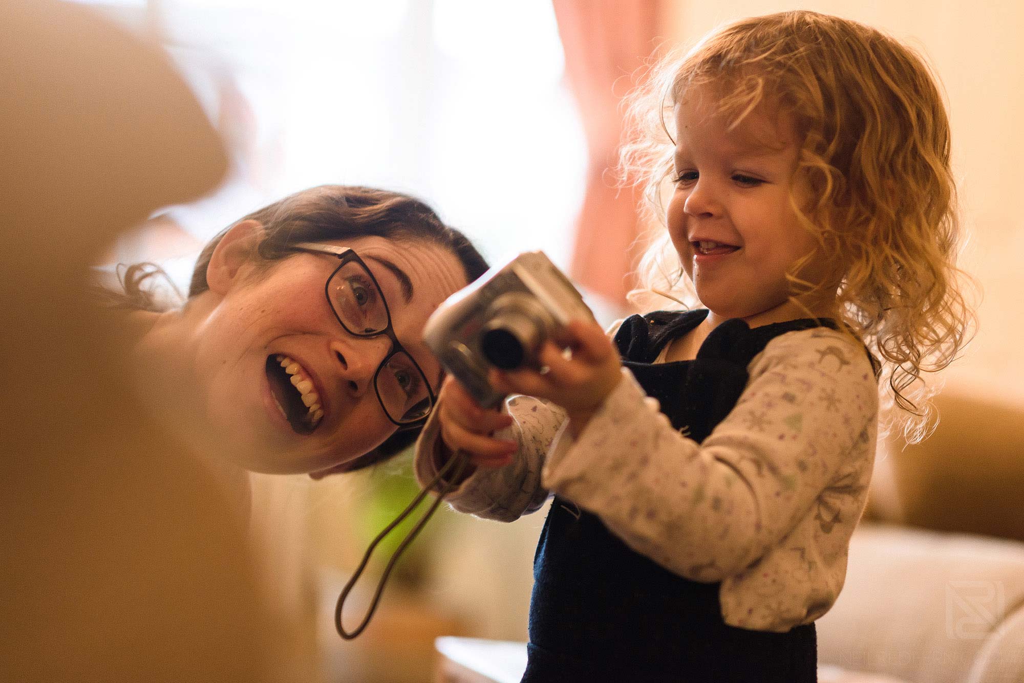 little girl playing with camera