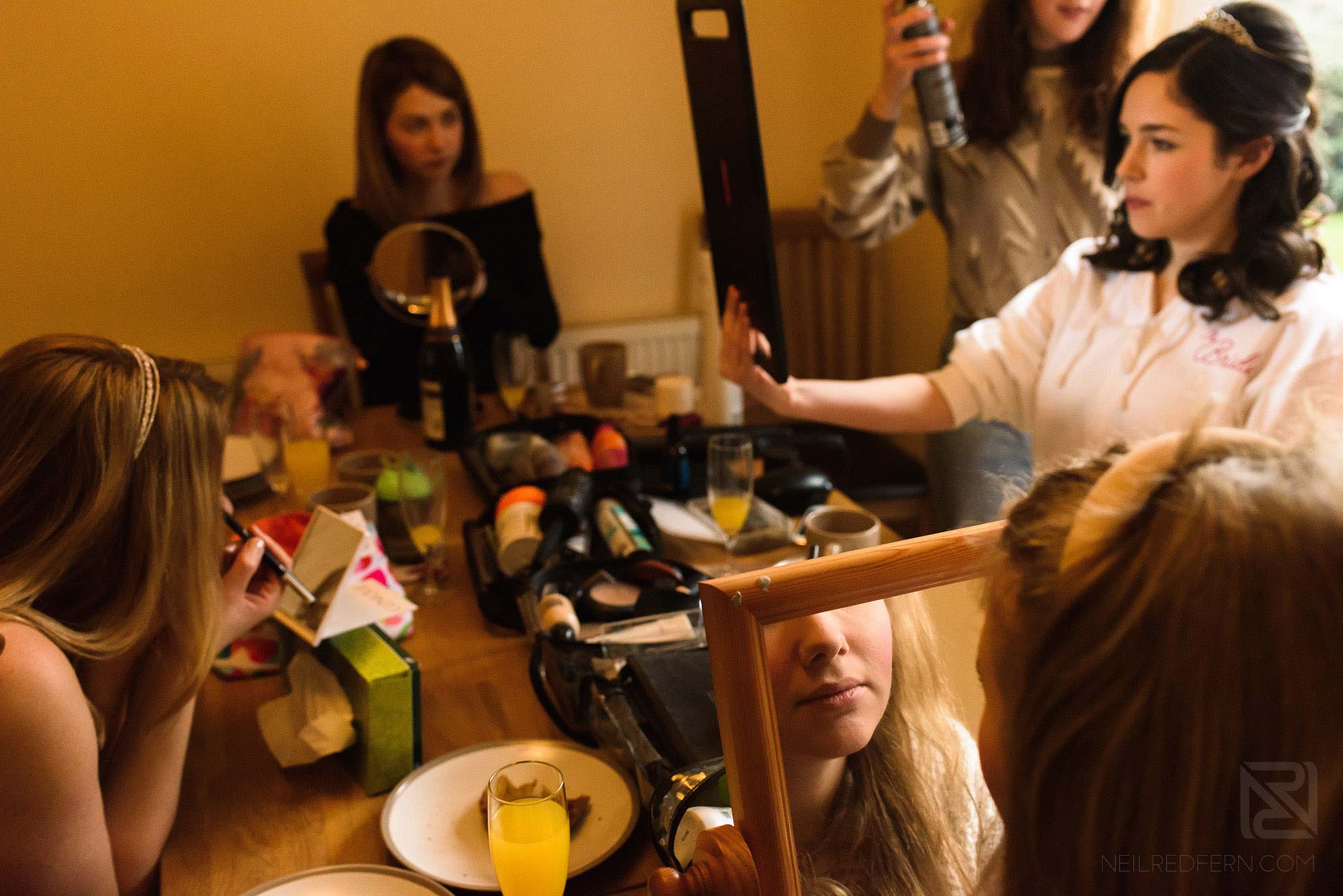 bridesmaids getting ready together on wedding morning