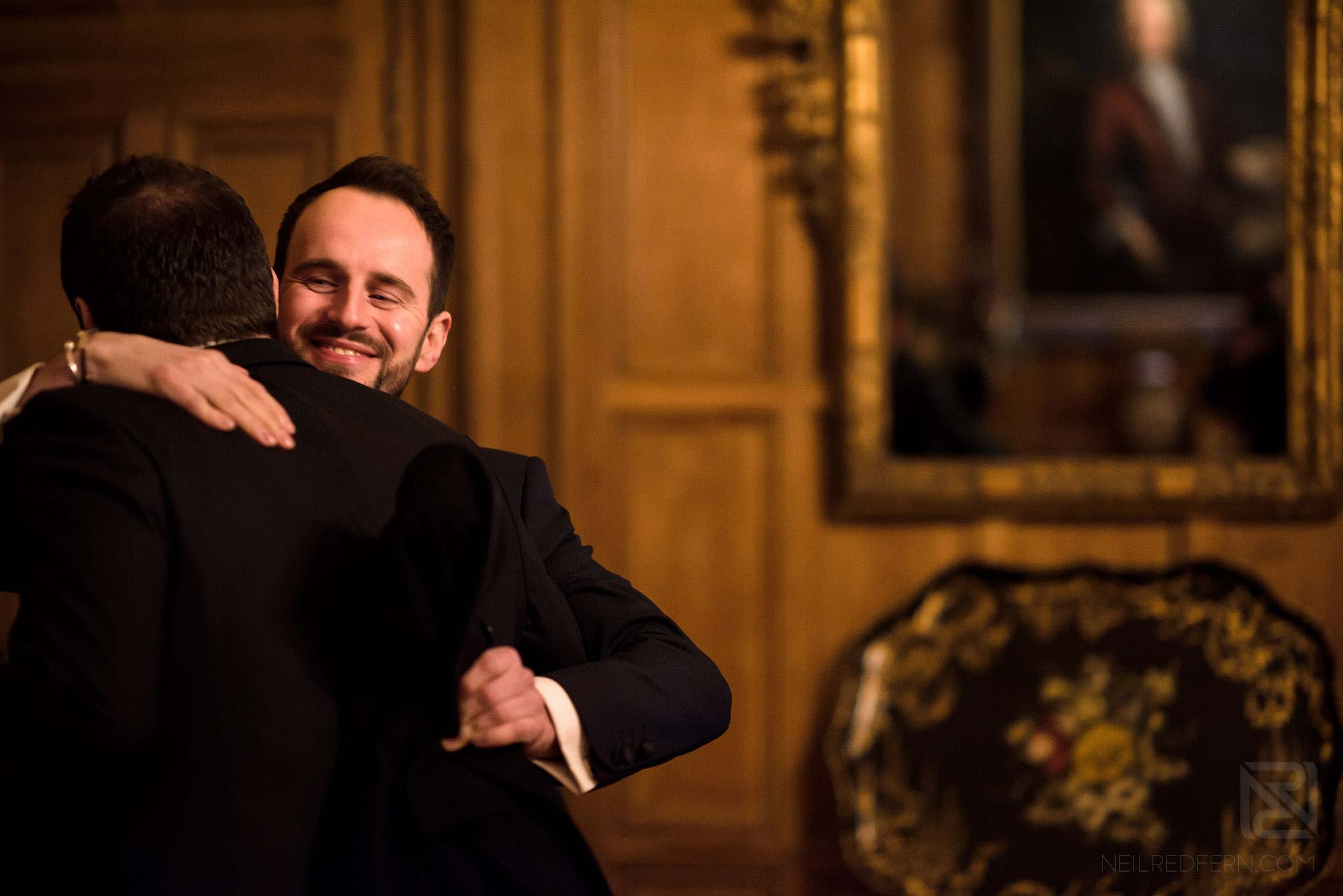 guest hugging groom at Arley Hall wedding