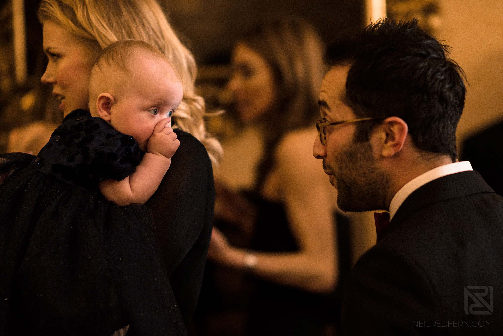 wedding guest playing with baby