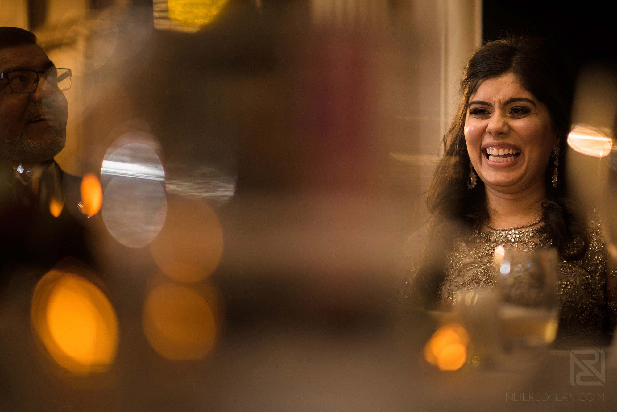 bride laughing during wedding speeches at Arley Hall