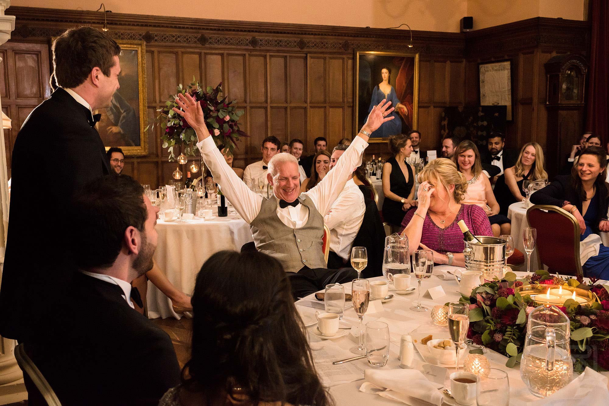 father of groom laughing during wedding speeches