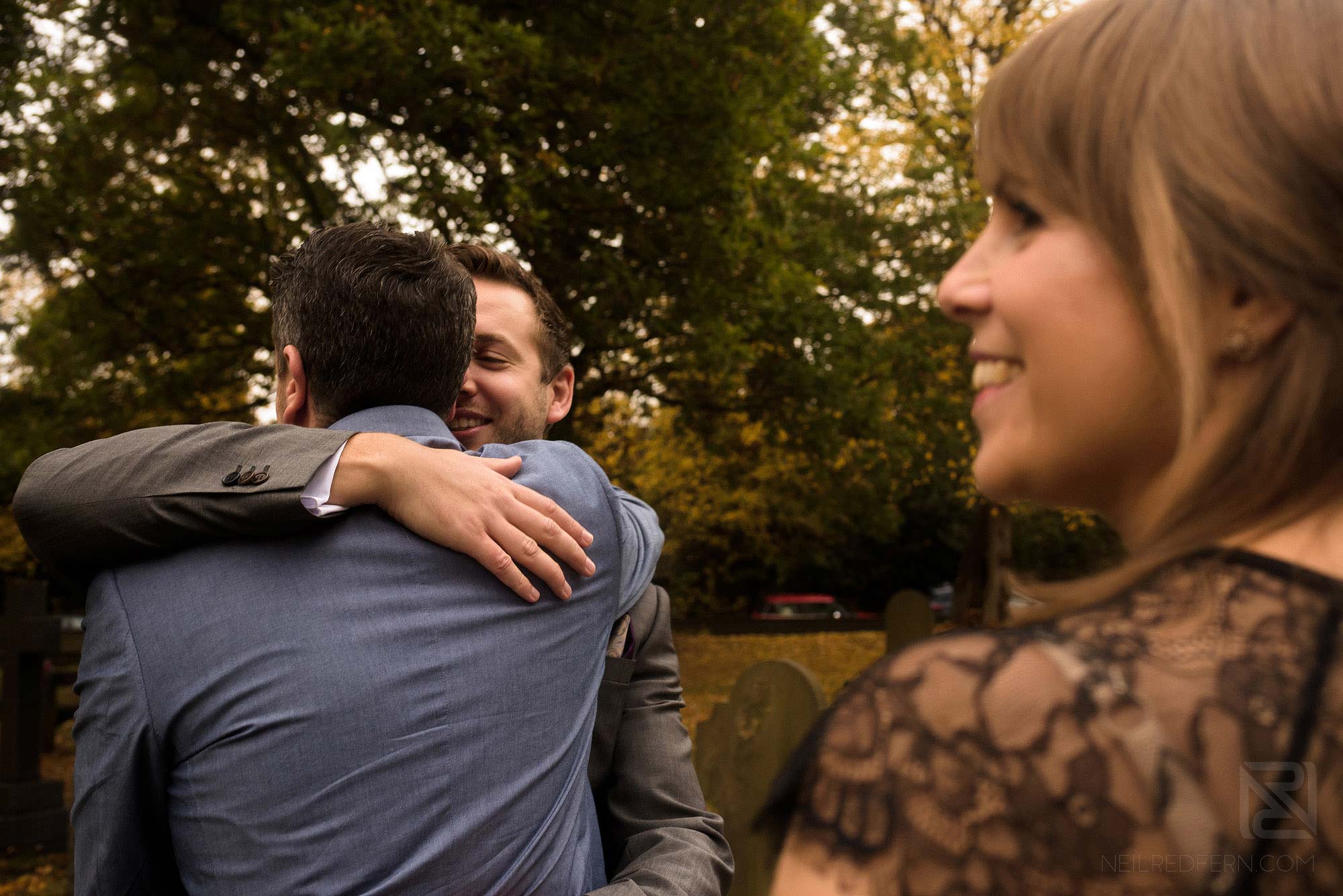groom hugging guests after wedding ceremony